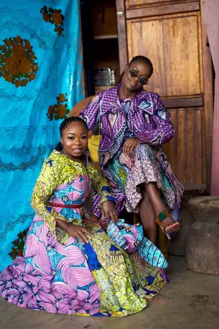 Two African women from the City of Joy modeling outfits made from Vlisco wax fabrics