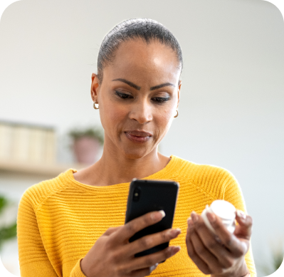 Woman with pills and mobile phone