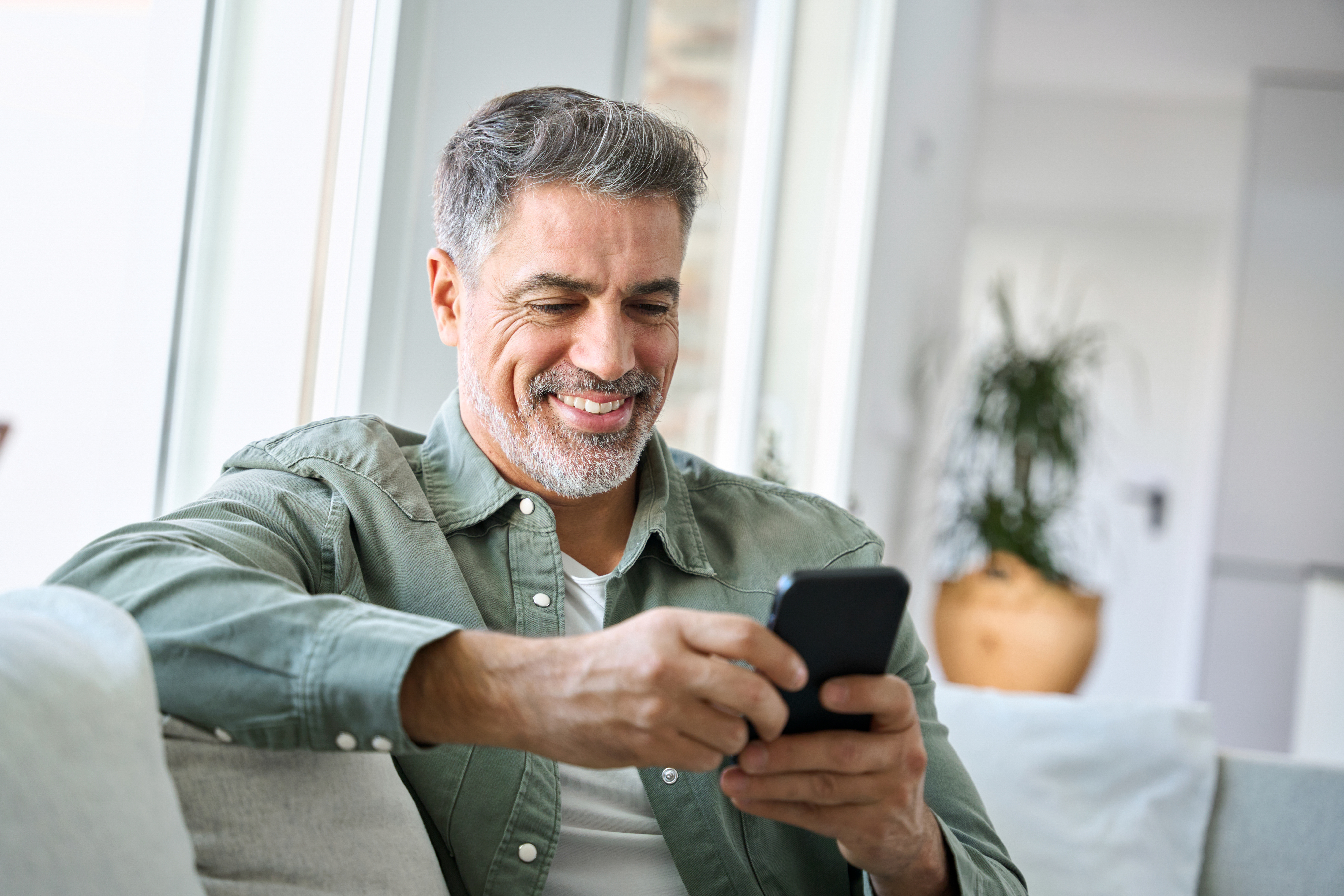 Member on phone smiling