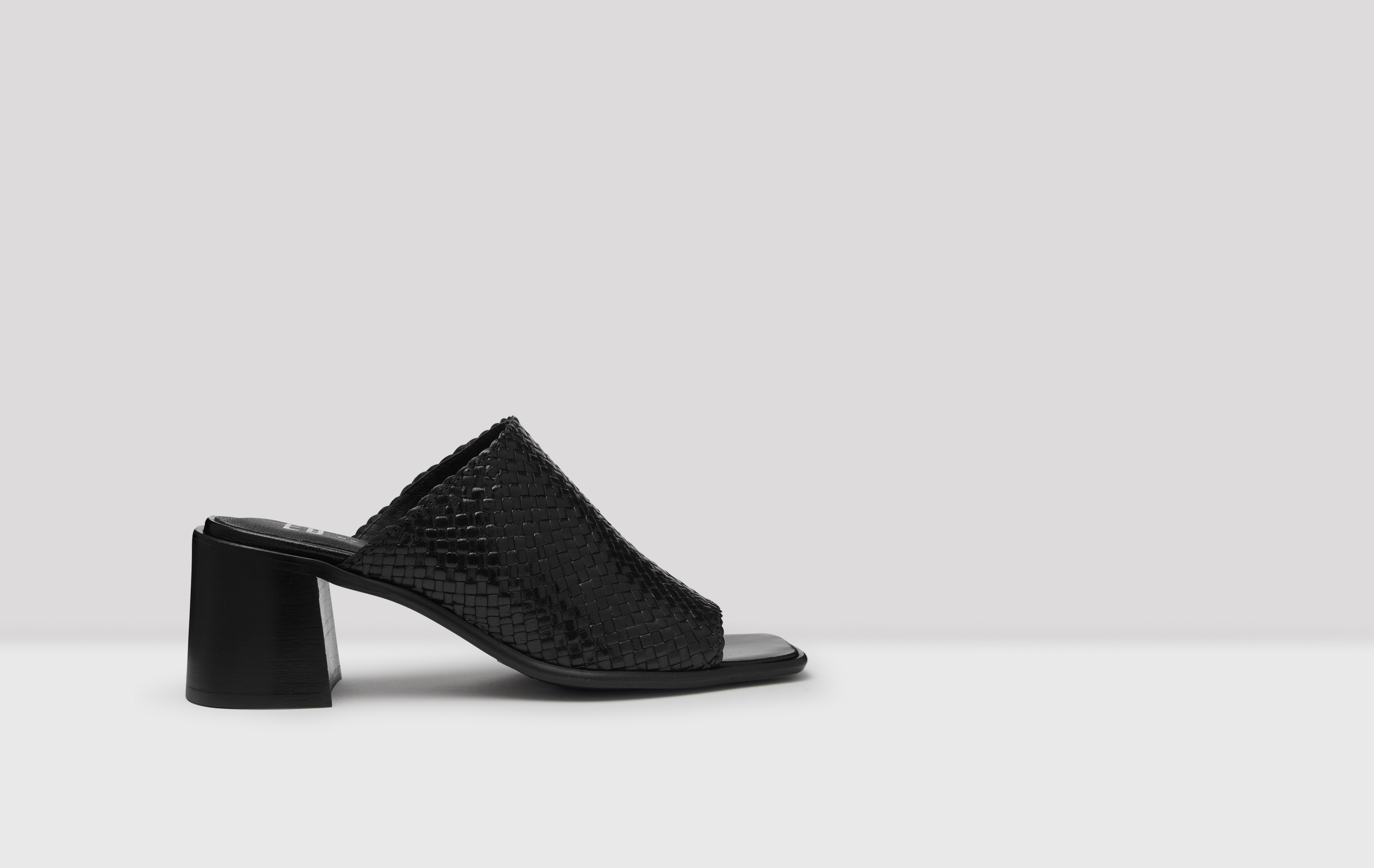 black woven leather mules
