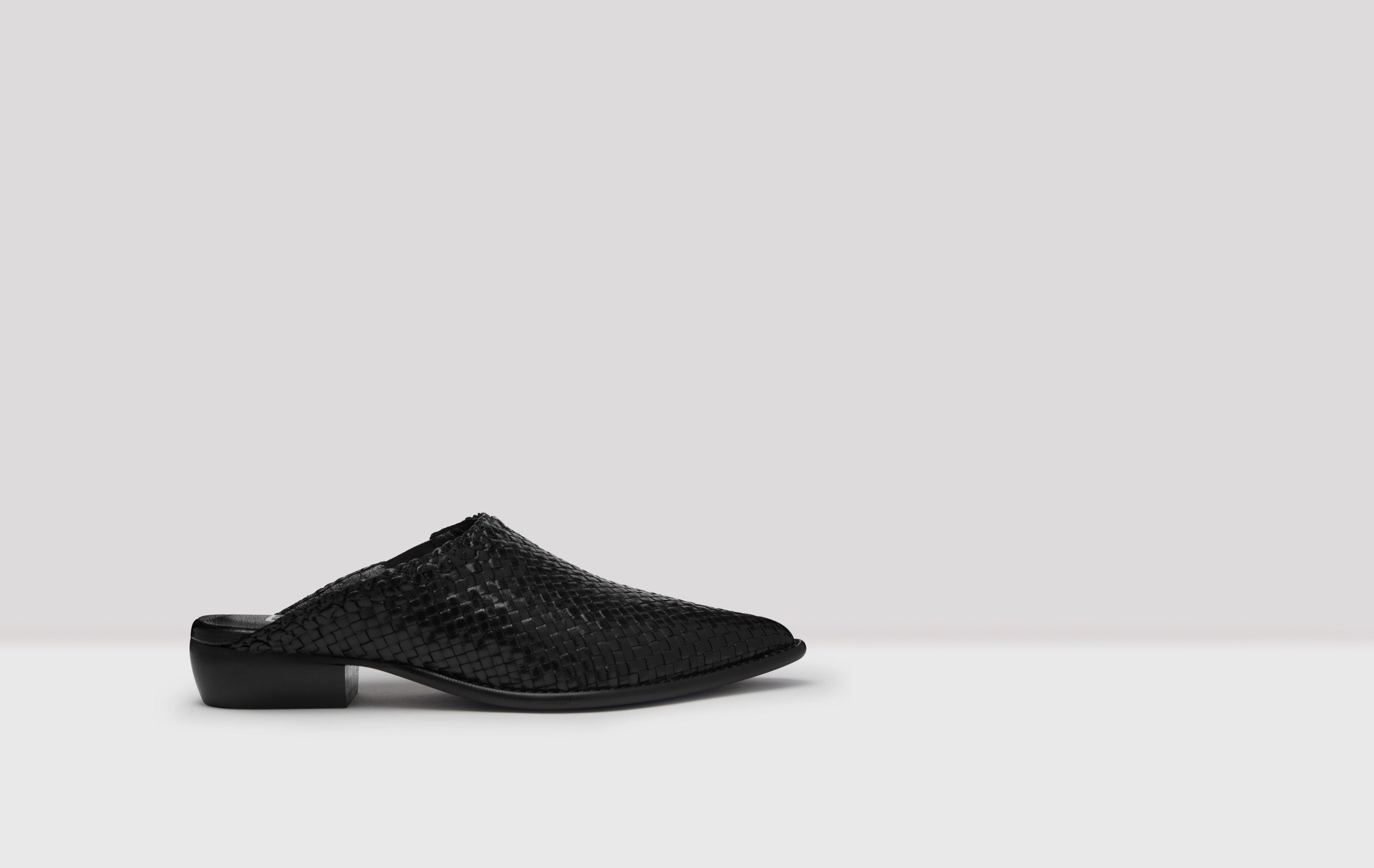 black woven leather mules