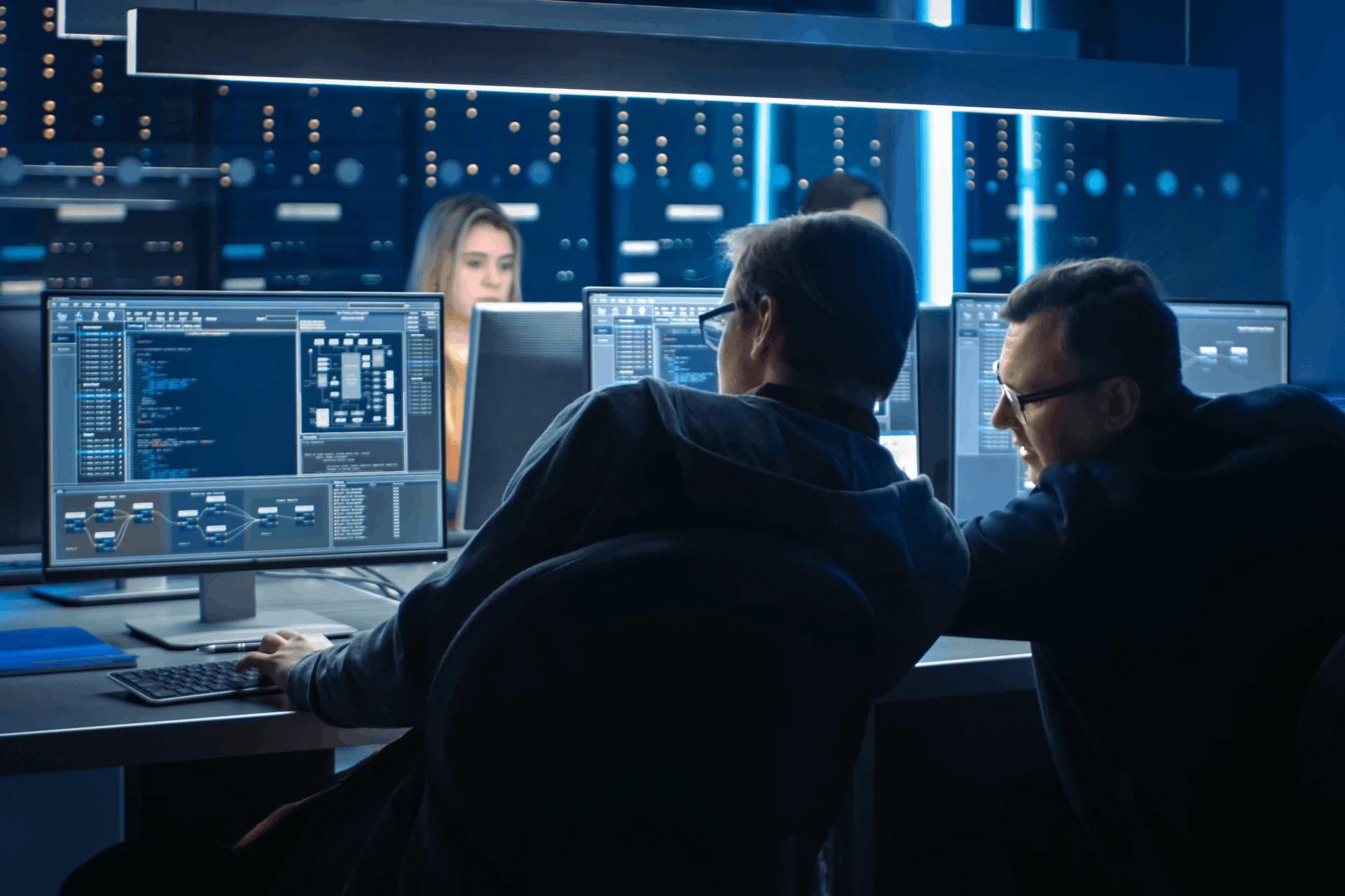 Professionals collaborating at computers on Kubernetes security tasks
