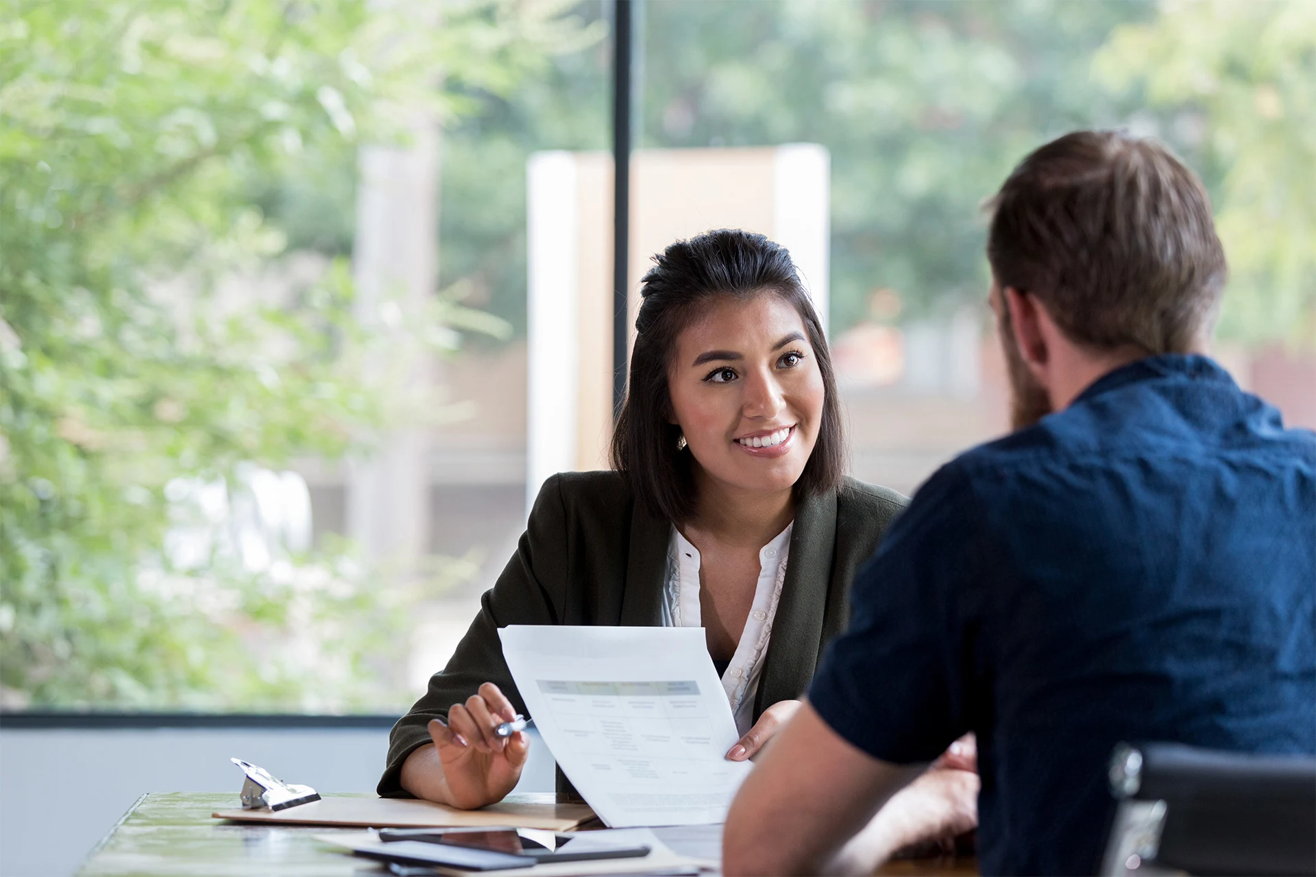Professional discussing documents during a meeting on cloud migration