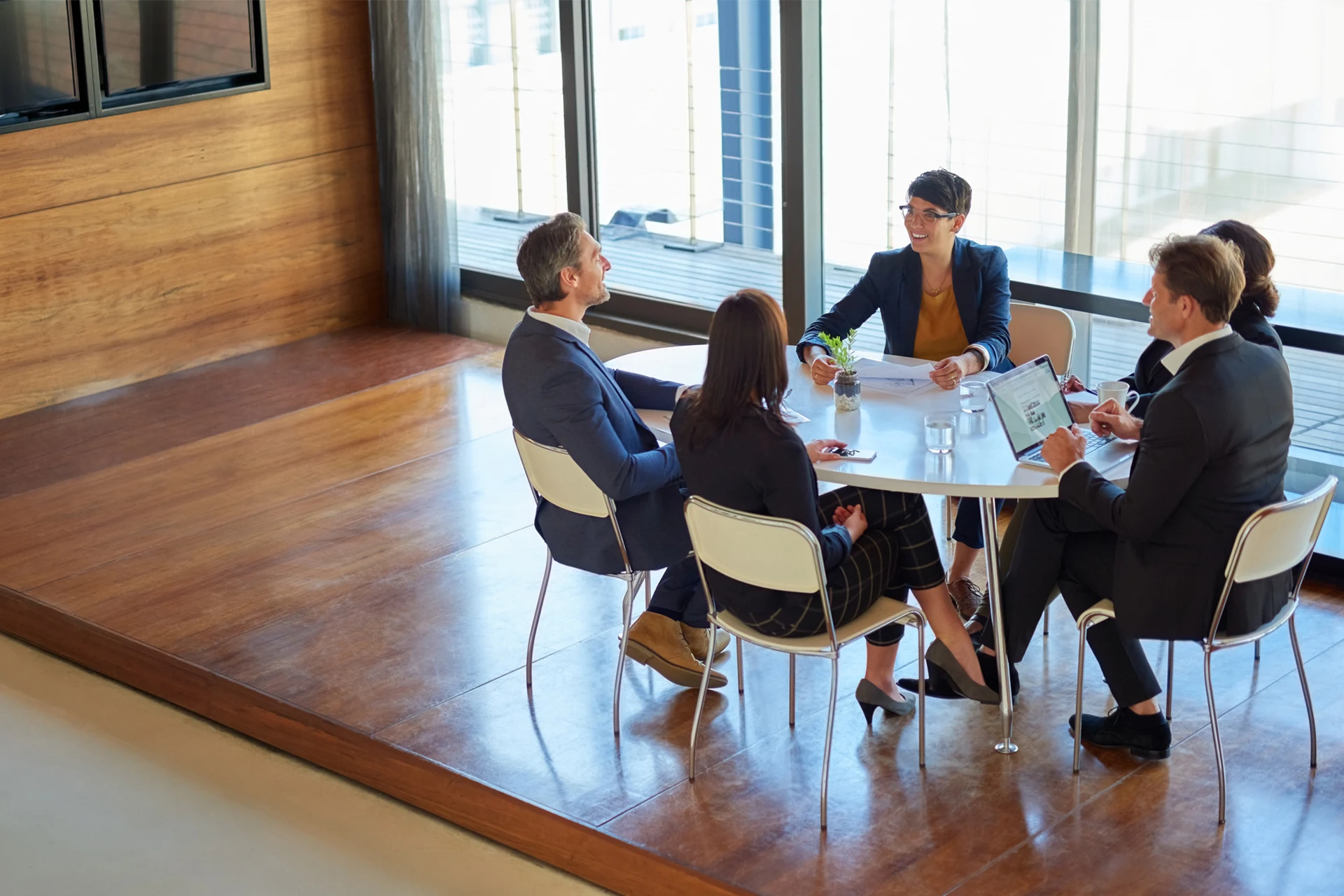 Group of professionals discussing strategies at a round table meeting
