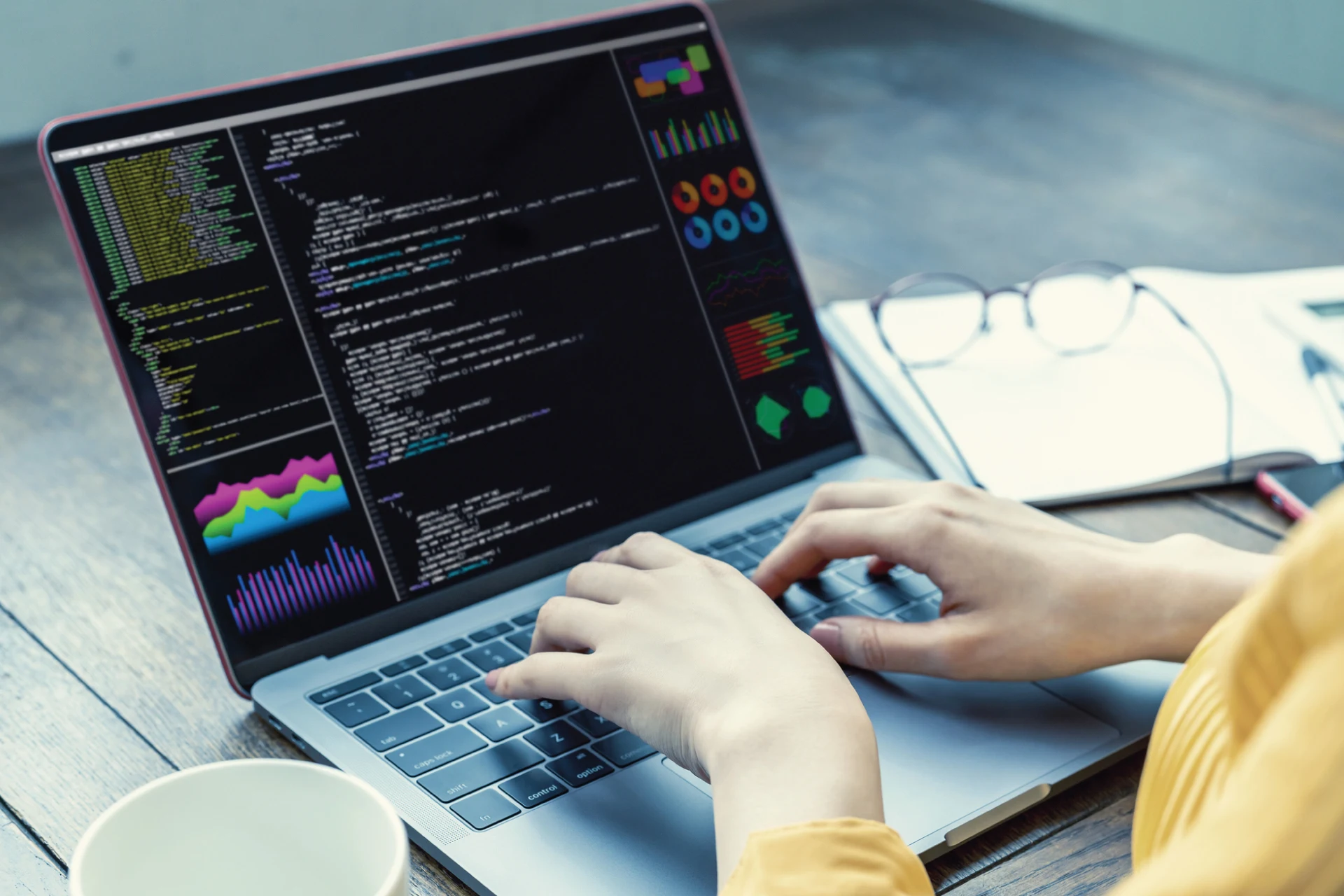 Laptop showing code and business analytics