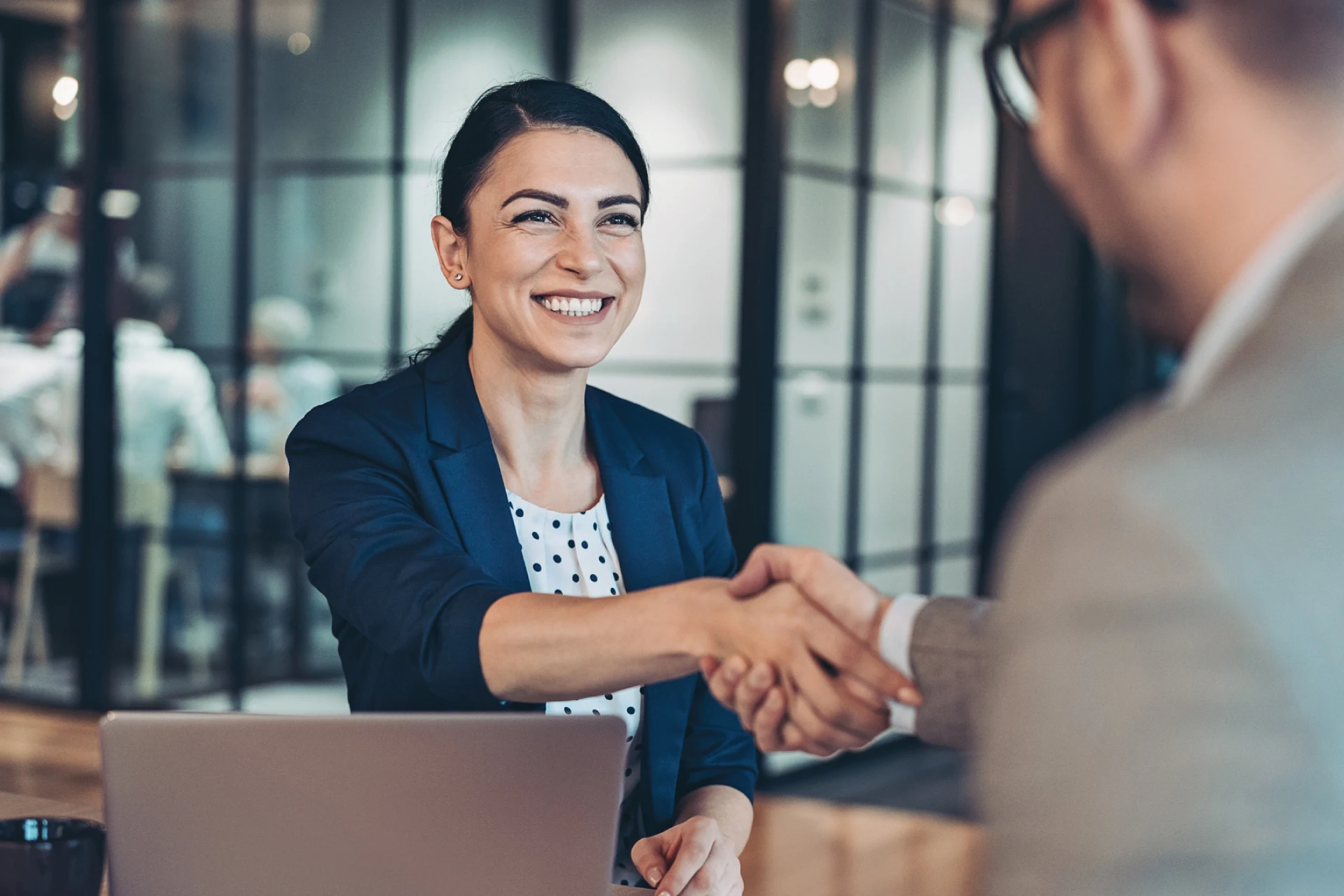 Business professionals shaking hands during a meeting