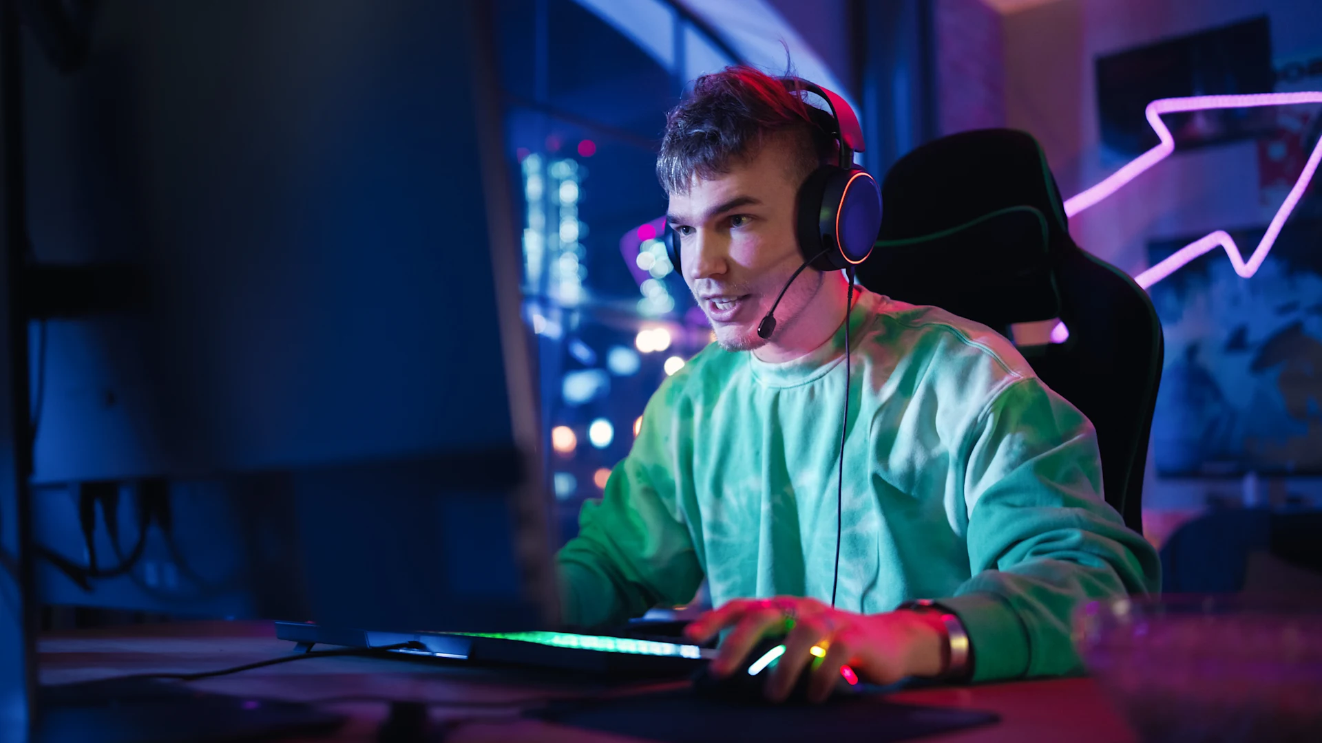 Gamer focused on computer screen during online gaming session