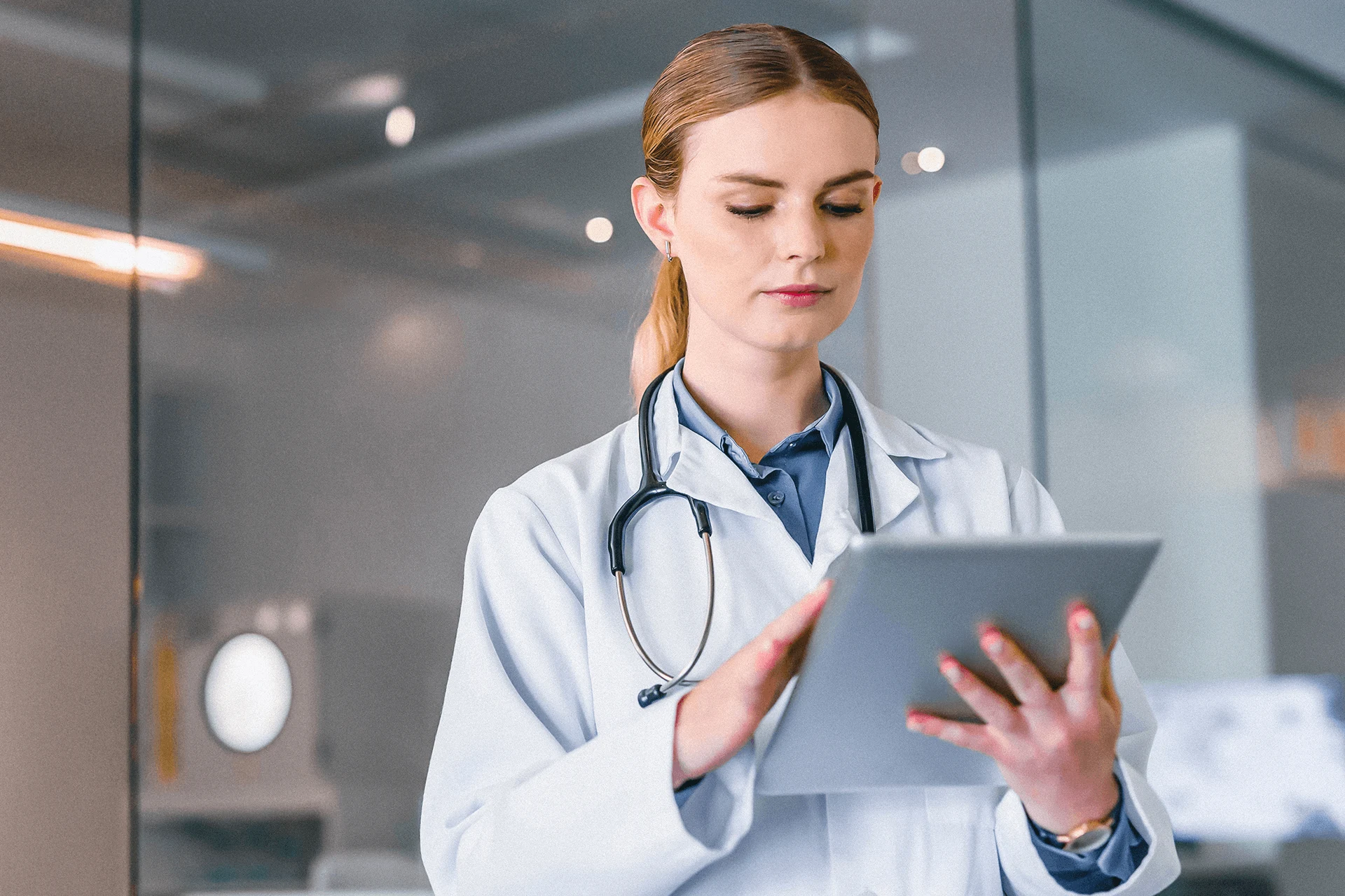 Healthcare professional using a tablet in a medical setting