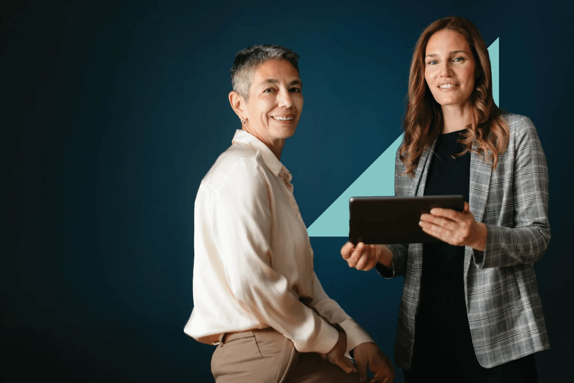 Two professionals discussing a tablet for IAM Lab architecture insights