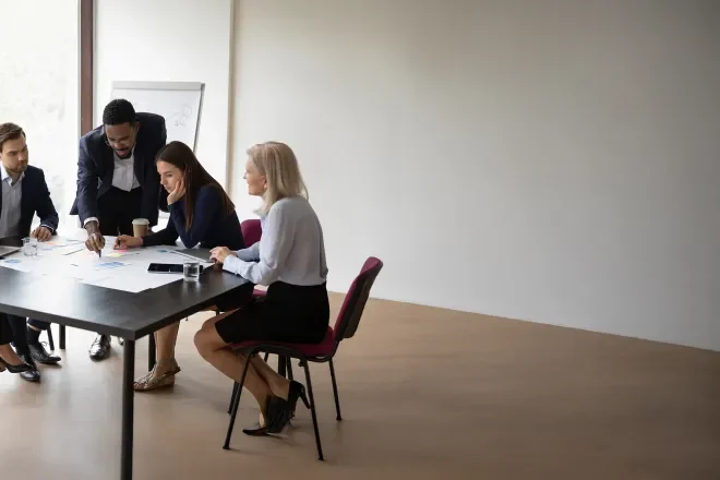 Group discussing strategies at a conference table during a business meeting