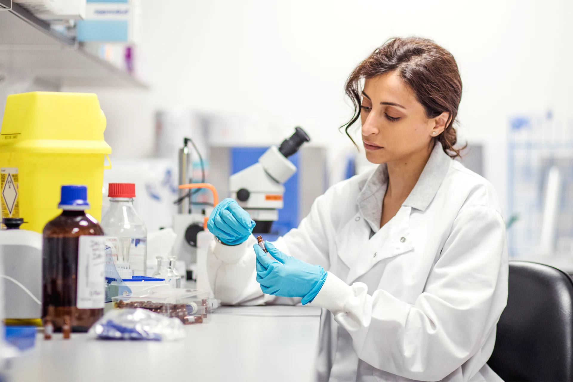 Scientist in a lab examining samples during drug development research