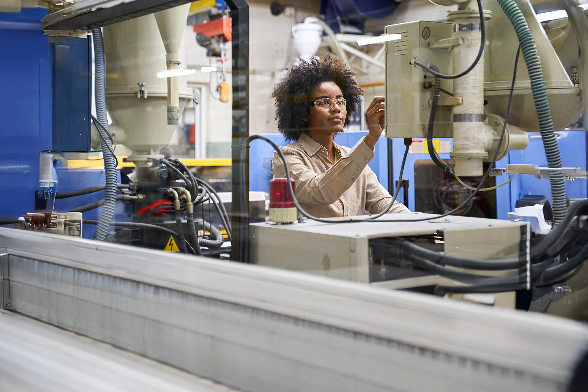 Industrial worker operating advanced manufacturing equipment