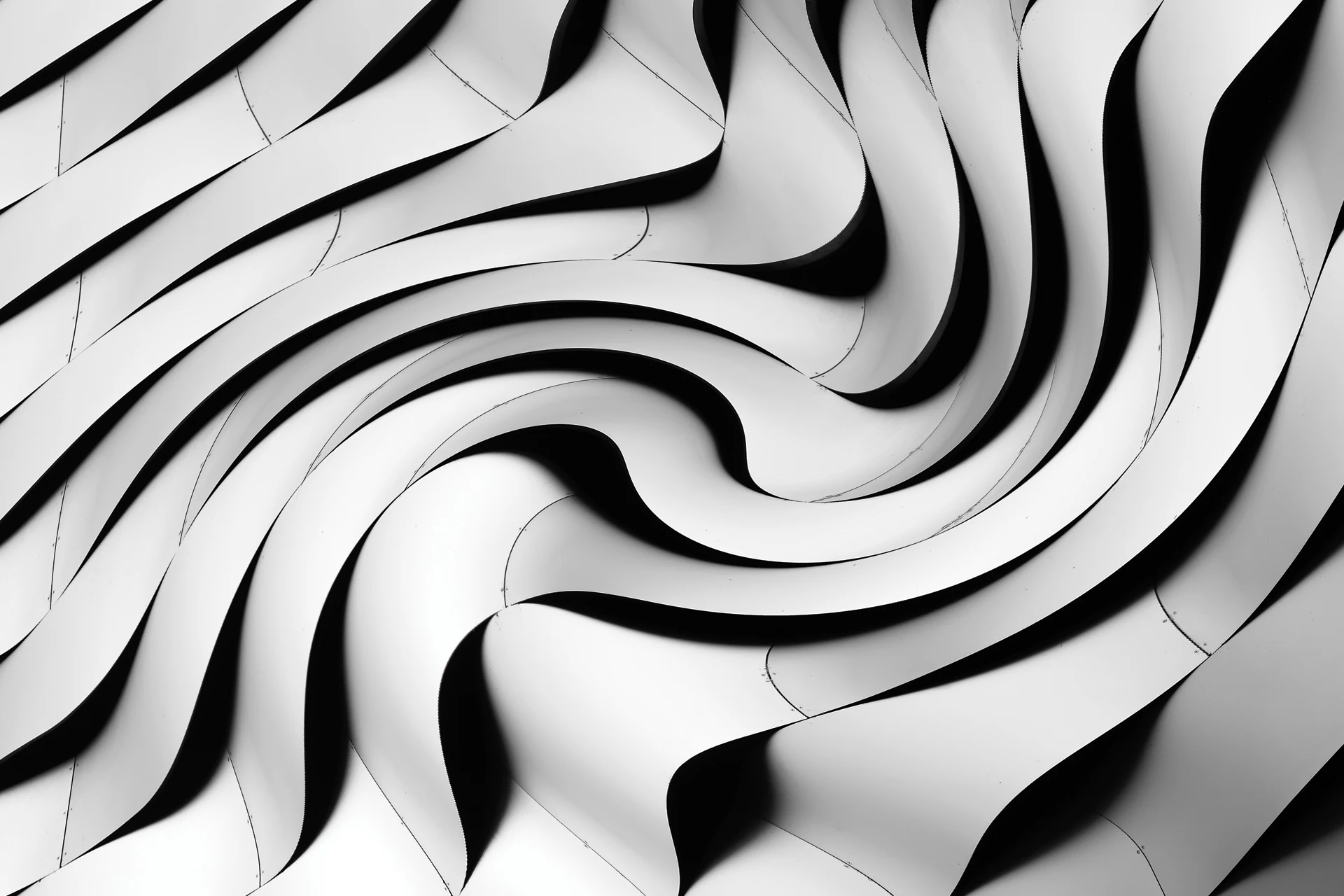 Layered metal panels forming a swirling architectural pattern.