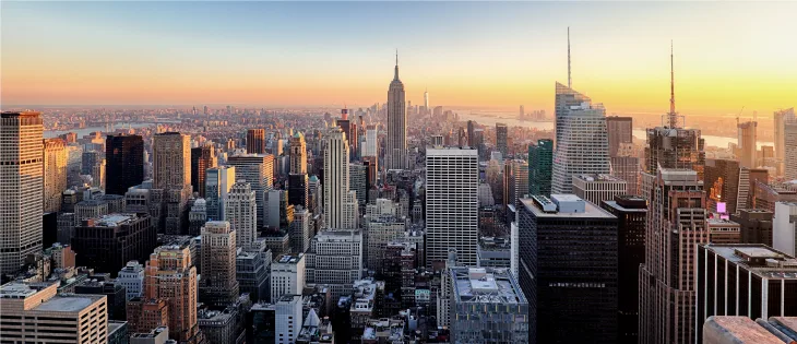 Panoramic landscape view of New York City NYC skyline buildings at sunset