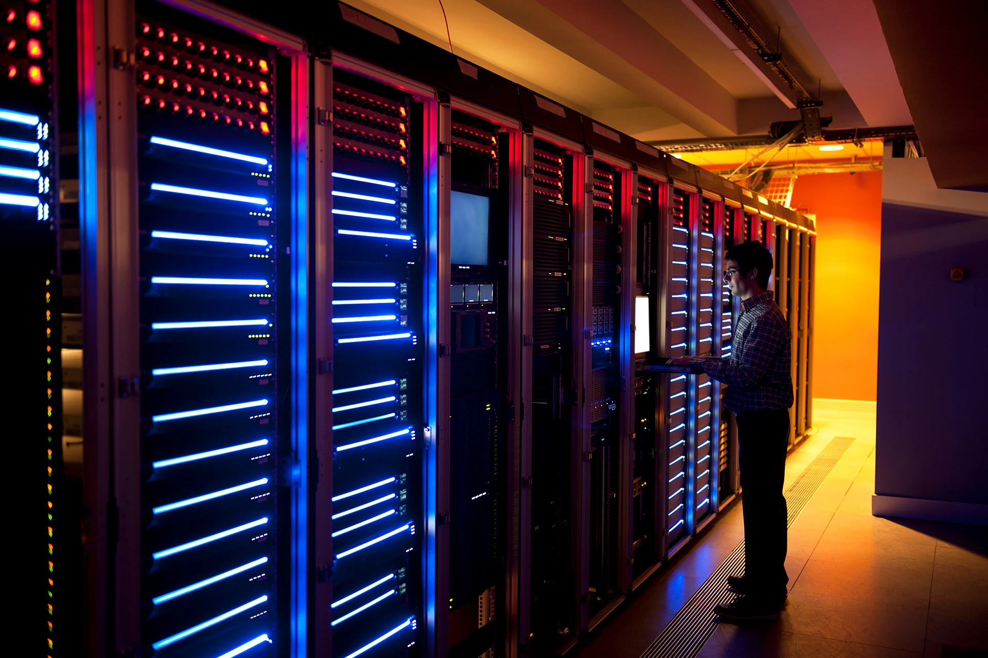 Technician monitoring cloud security systems in a server room