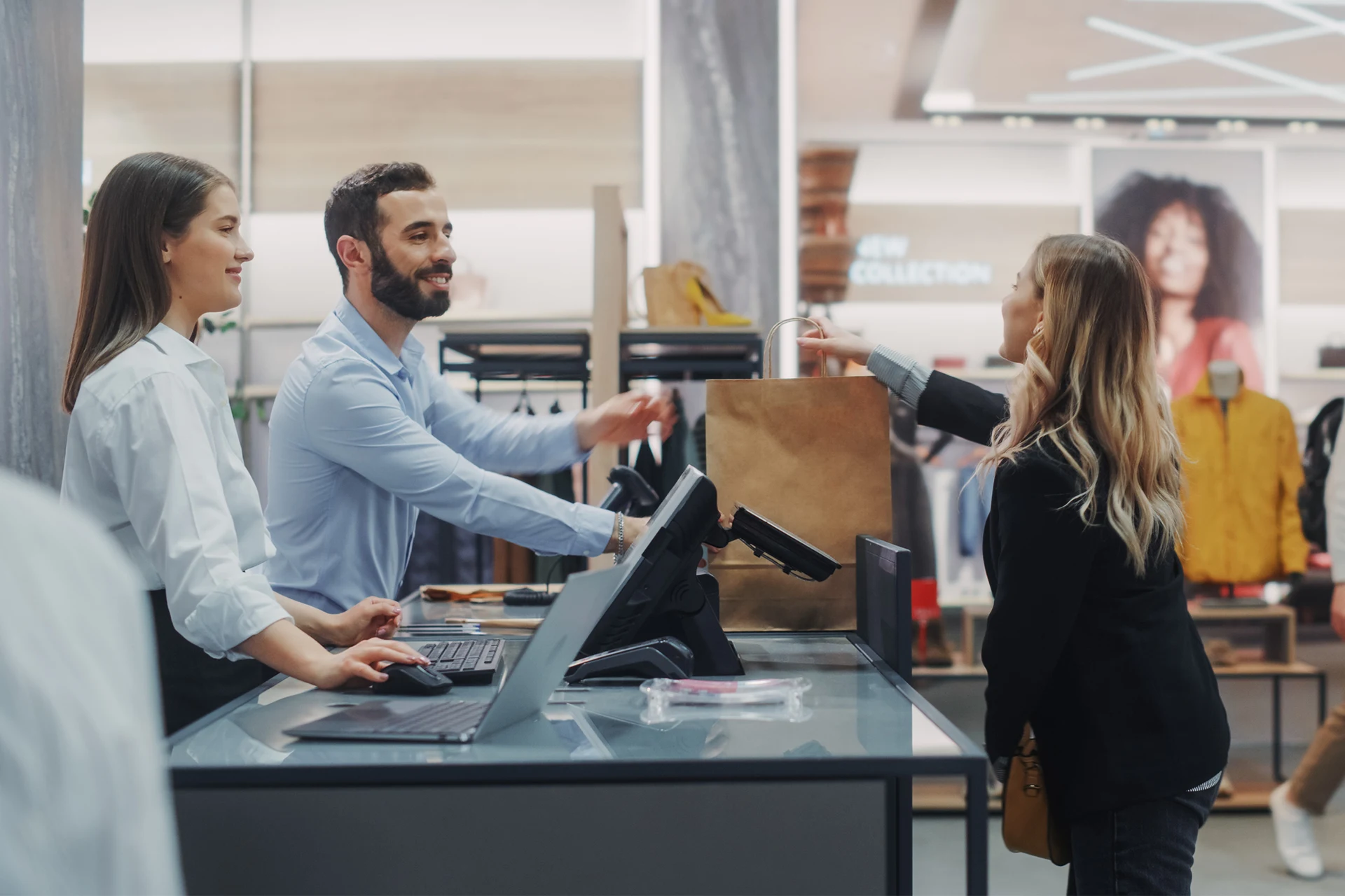 Customer returning an item at a retail checkout with staff assistance.