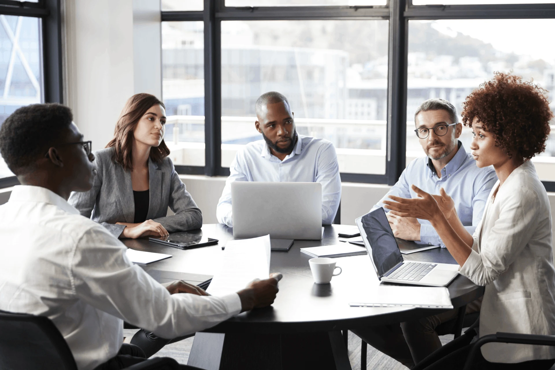Professionals engaged in discussion during a business meeting