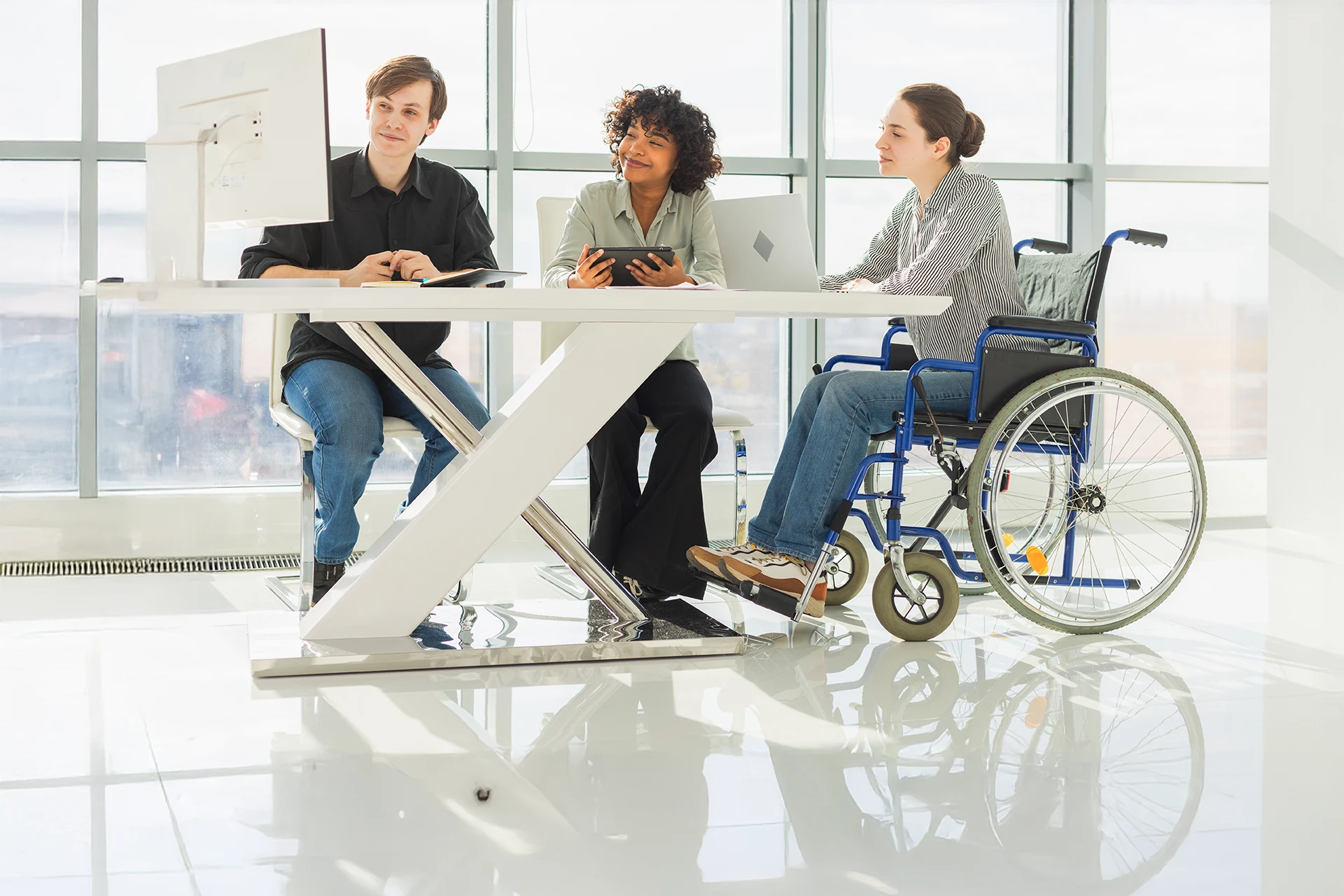 Diverse professionals collaborating, including a wheelchair user