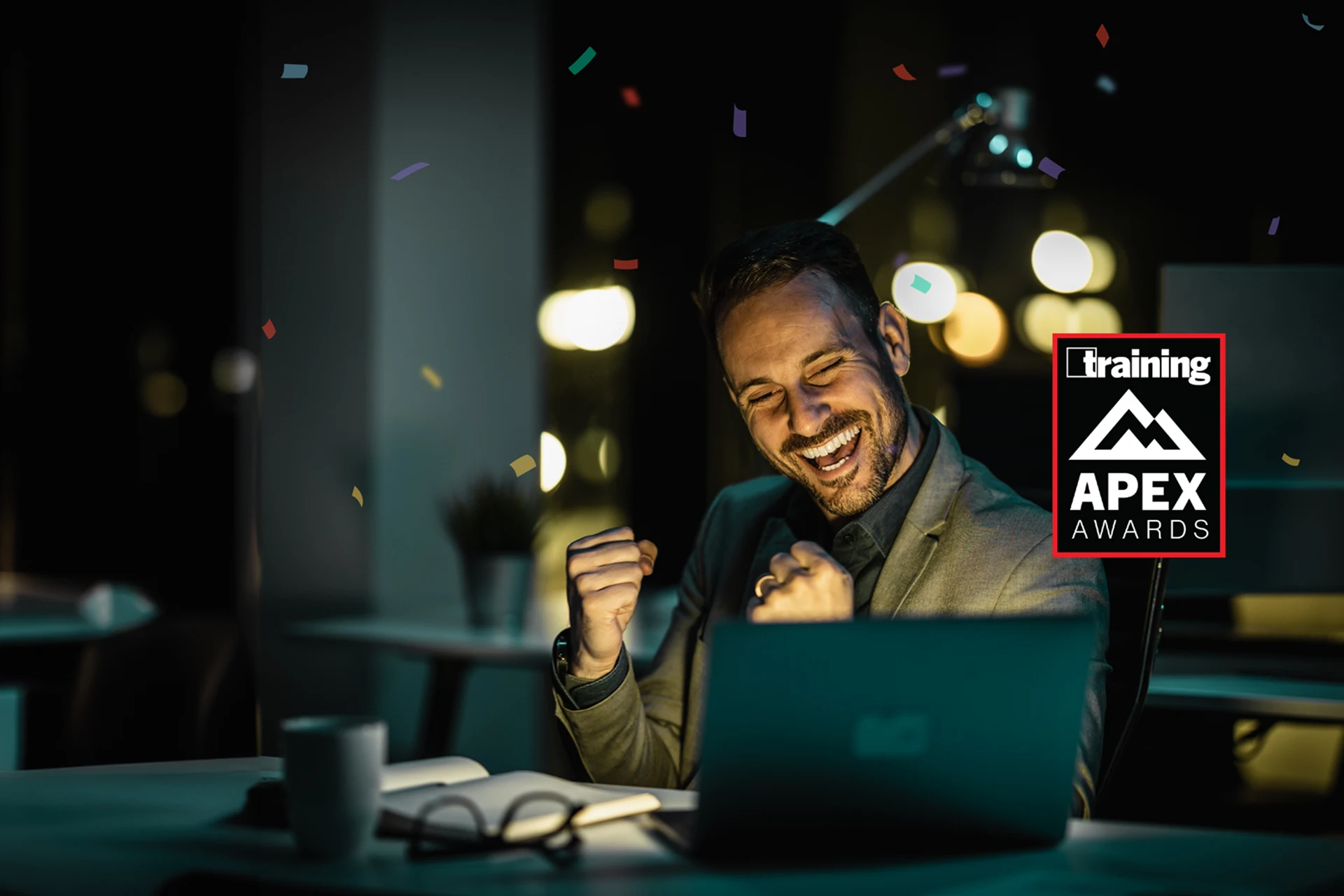 Celebrating Zensar 2024 Training APEX Awards win with laptop and confetti