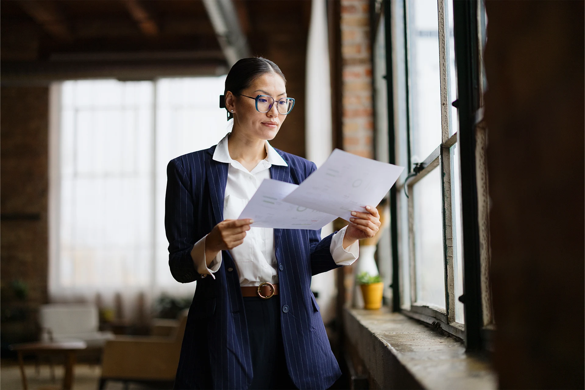 Professional reviewing documents in a bright office setting
