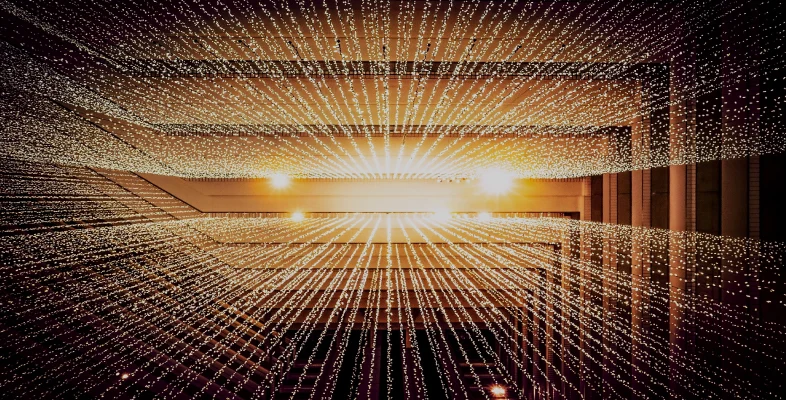 Illuminated linear light streams on modern architectural hallway ceiling