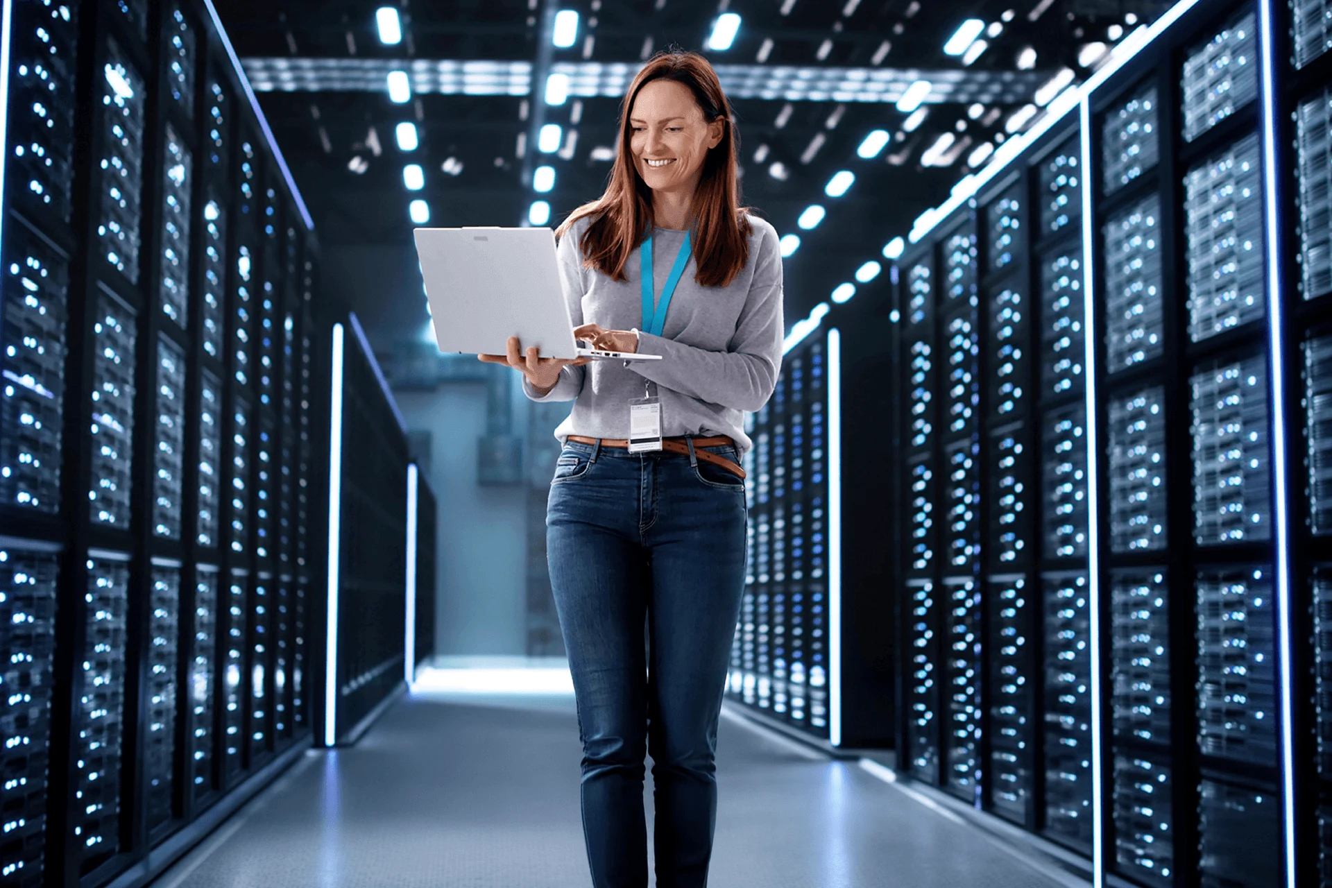 Woman using a laptop in a data center during digital transformation project