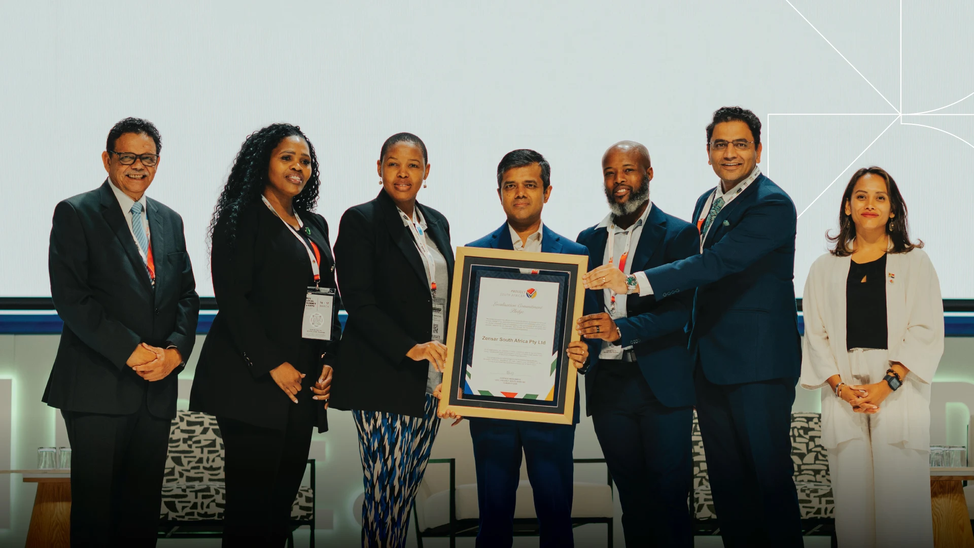 Zensar team receives Proudly South African membership certificate on stage