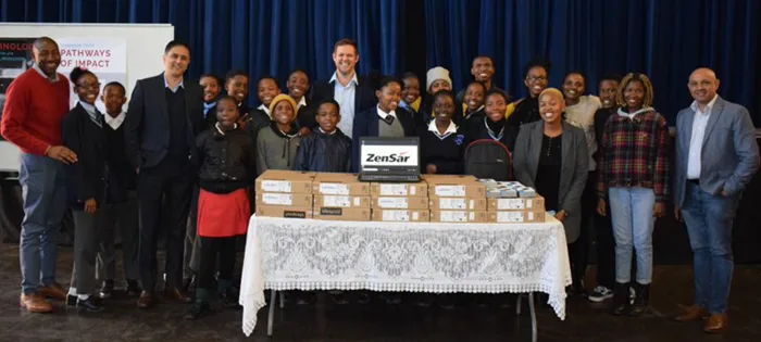 Group photo of Zensar team with laptop and Tomorrow Trust program students
