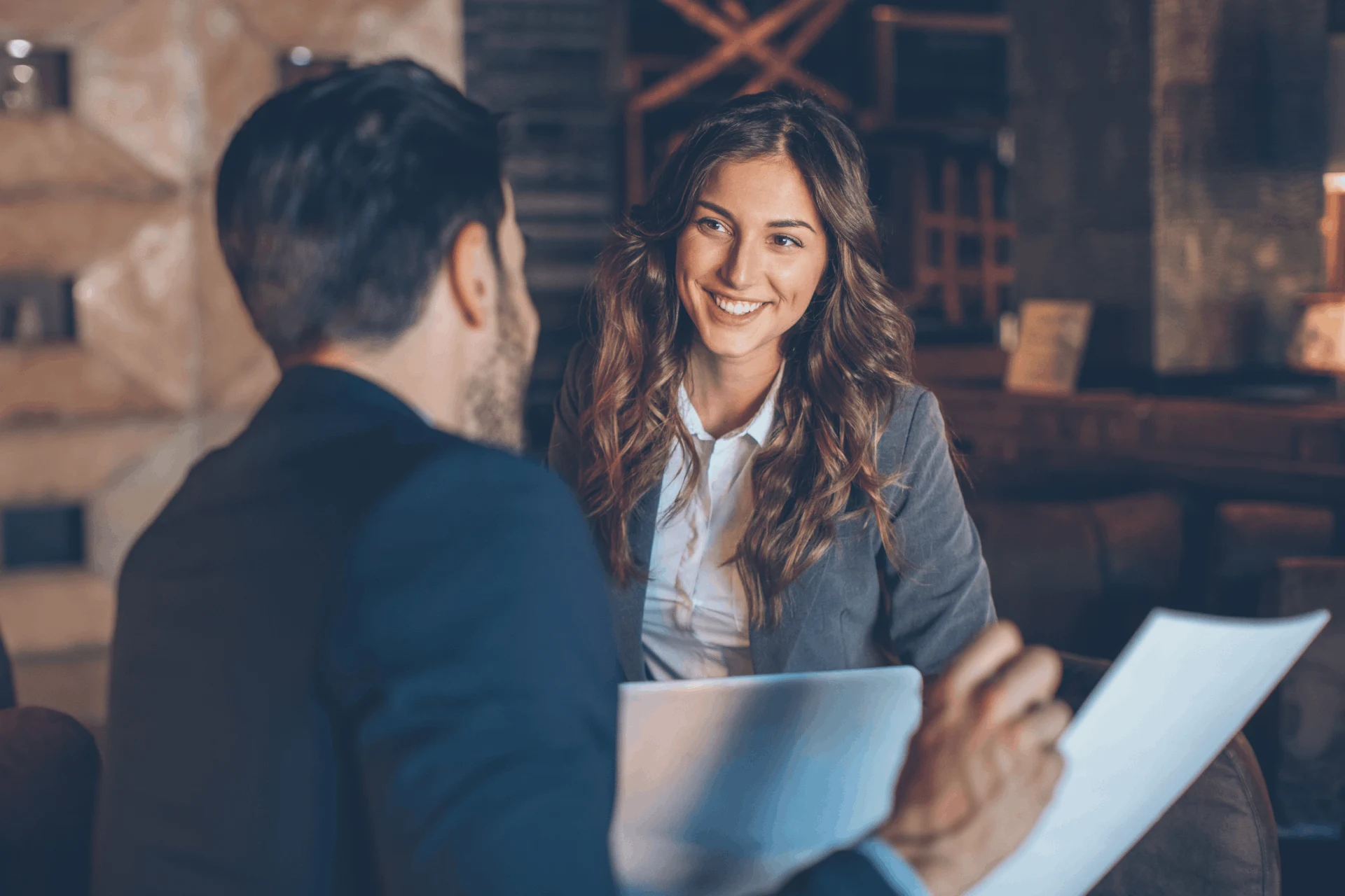 Business professionals discussing documents in a casual meeting setting