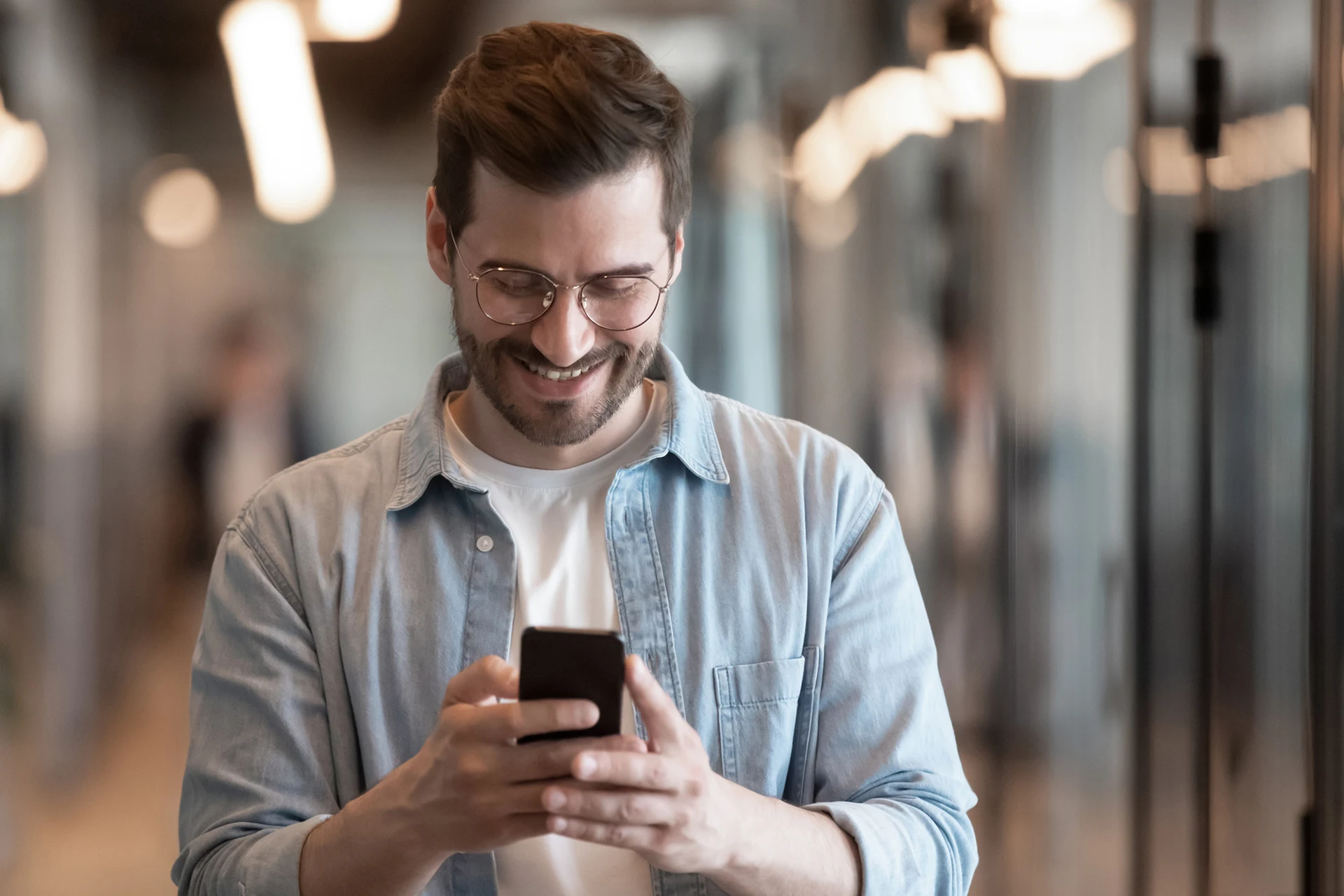 Person holding a smartphone, focused on customer engagement solutions.