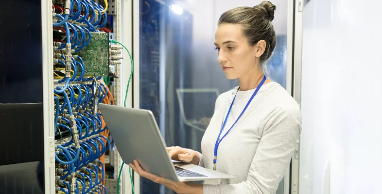 Professional managing data storage with a laptop for backup solutions