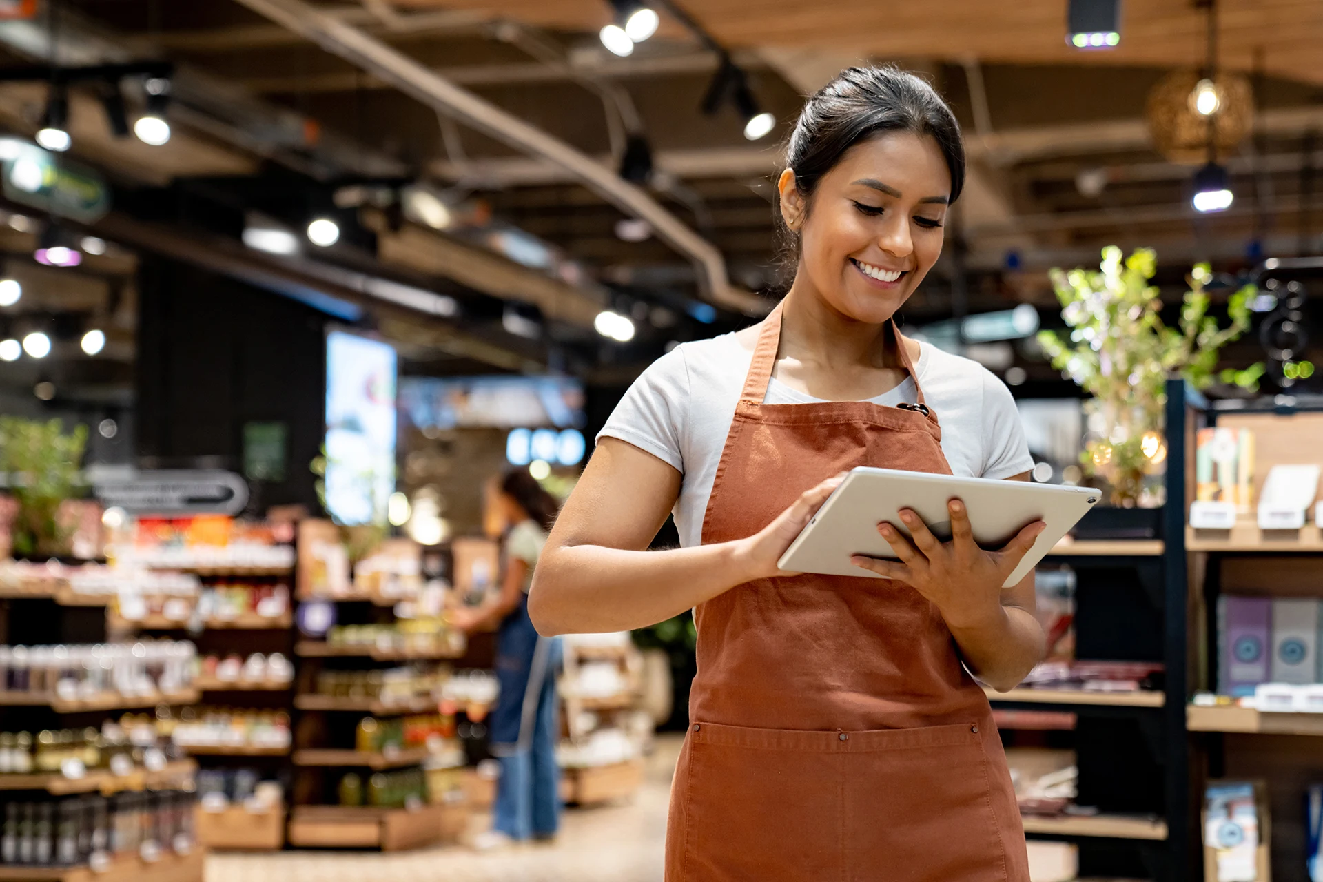 Retail store employee using a digital tablet for inventory management