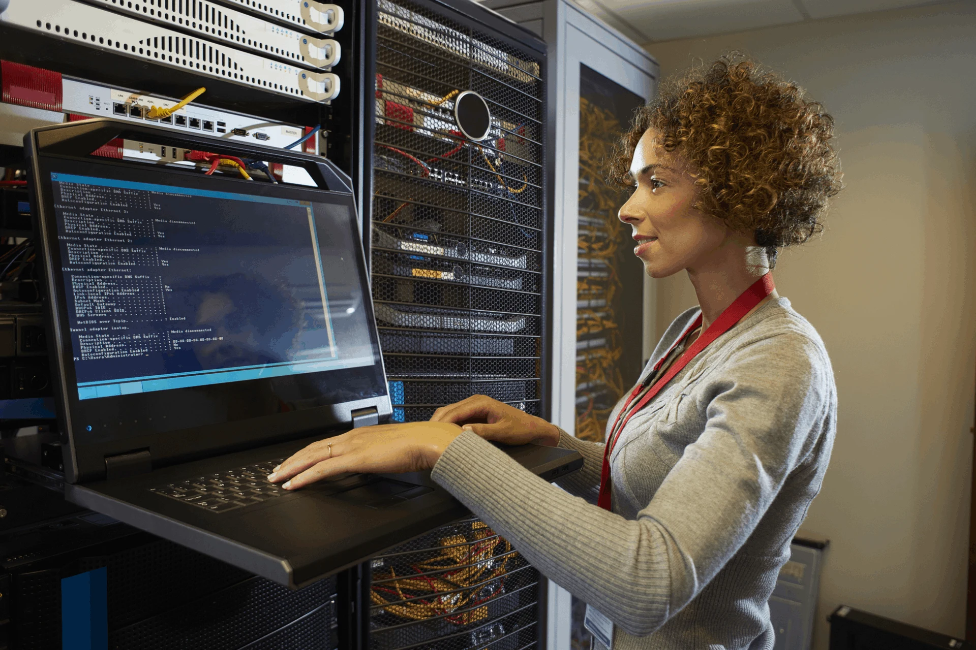 Professional working on a laptop in a server room for Azure Logic Apps
