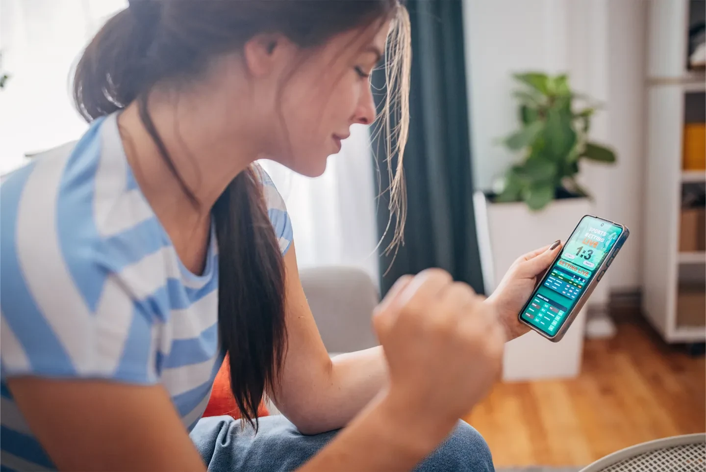 Person engaging with a mobile app related to gaming and user experience.
