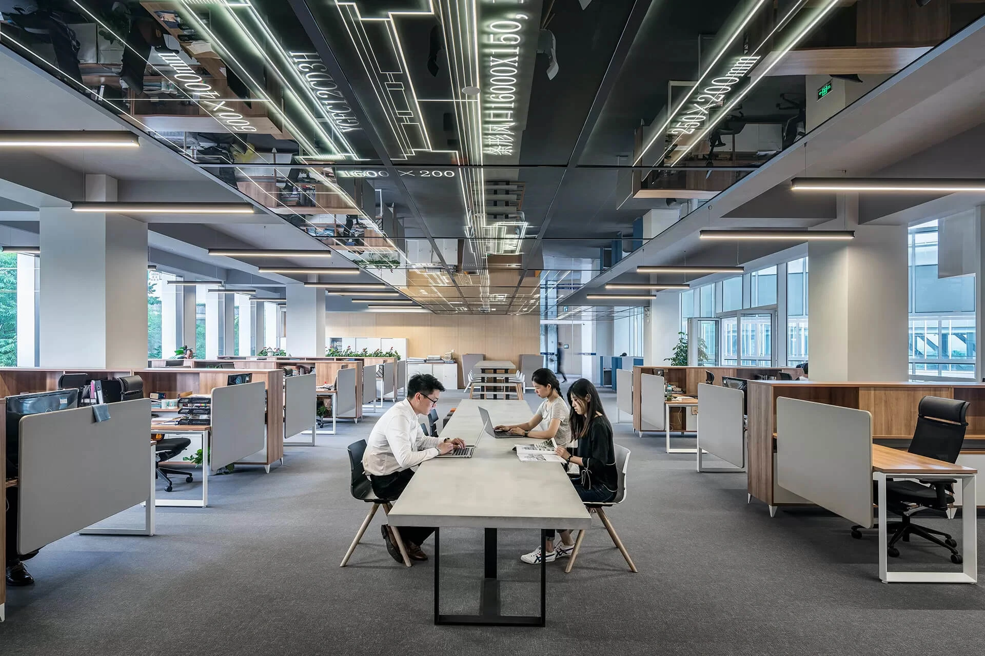 Two professionals collaborating at a table in a modern office space