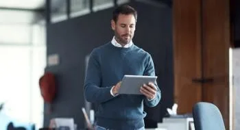 Corporate professional standing and using tablet for ISG Provider Lens report