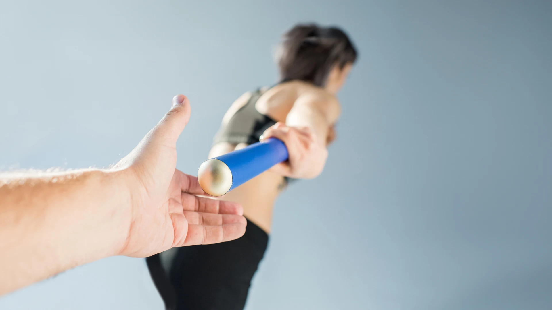 Hand passing relay baton symbolizing Zensar mLogica mainframe modernization