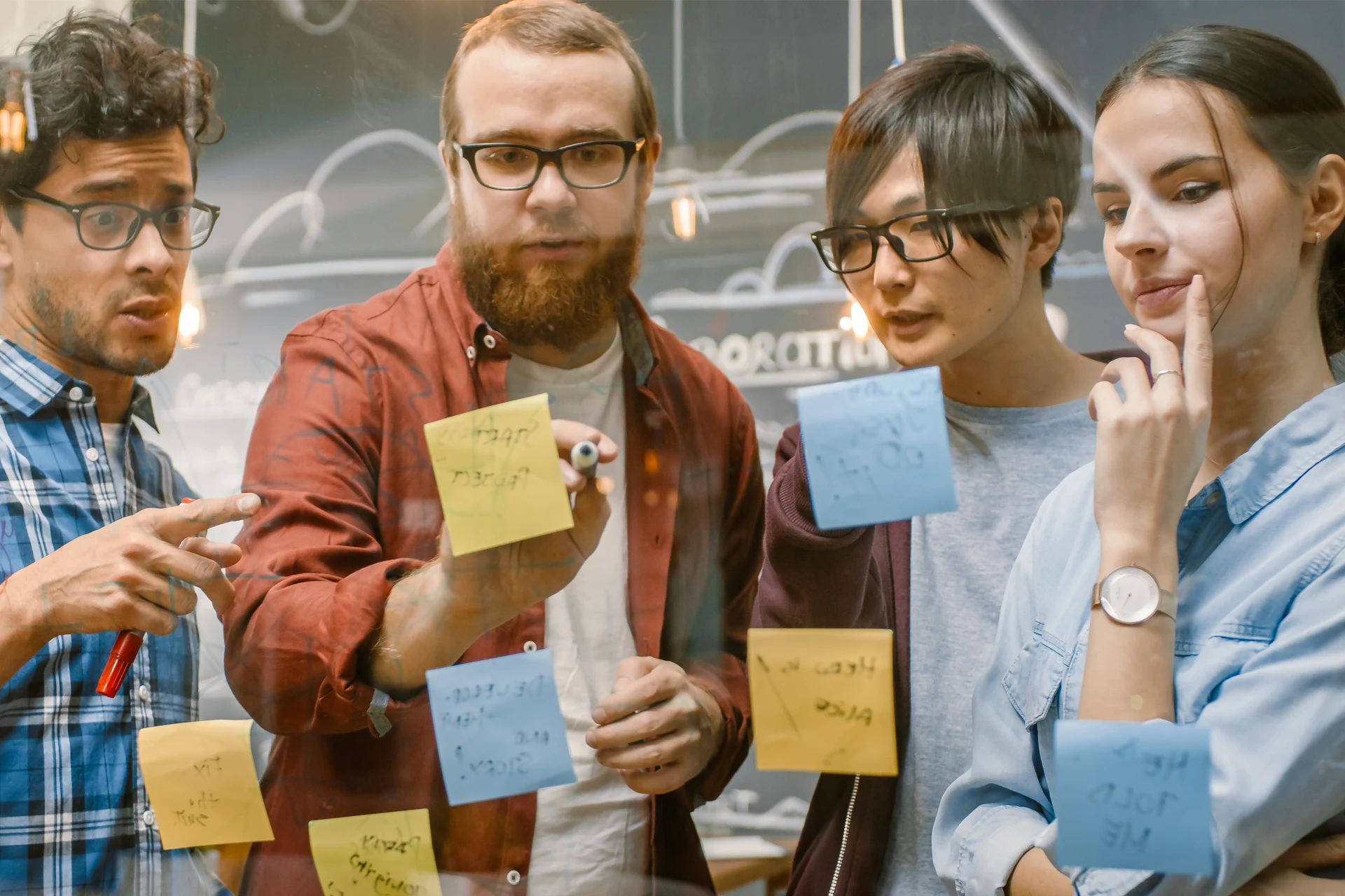 Team collaborating on DevOps strategies using sticky notes in a workshop