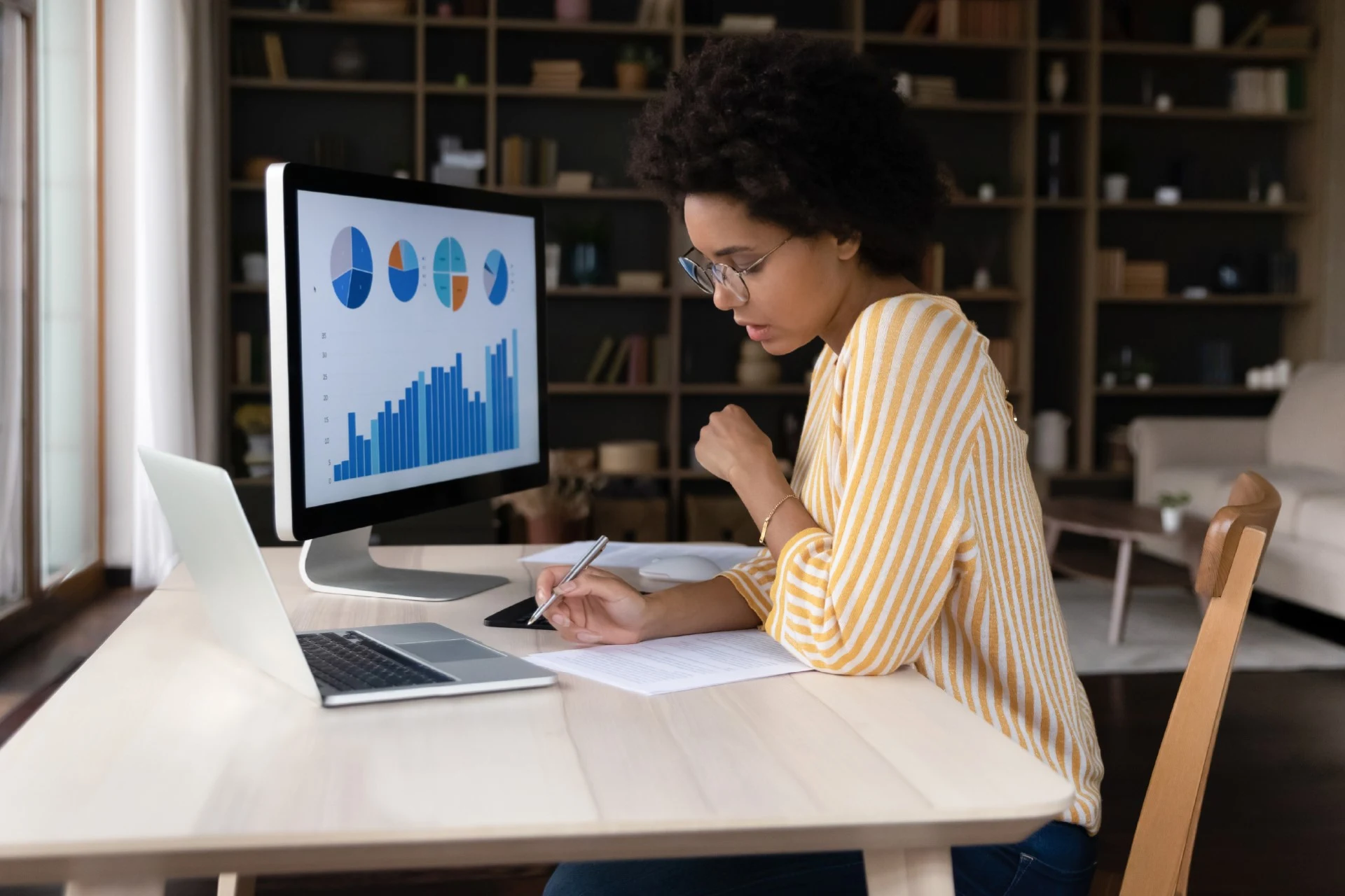 Professional analyzing data on a monitor for a banking case study.
