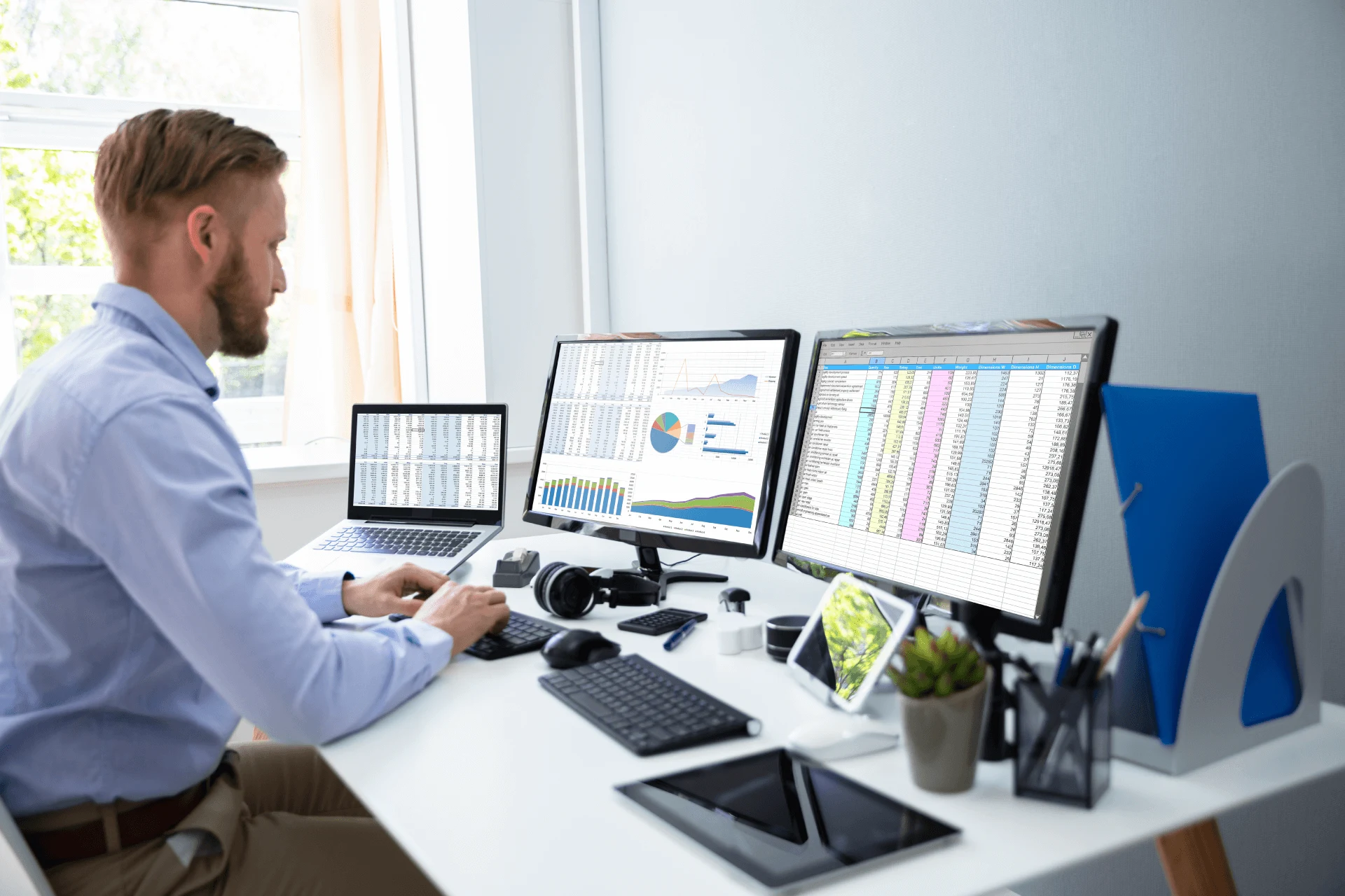 Professional working on multiple screens displaying data analysis reports