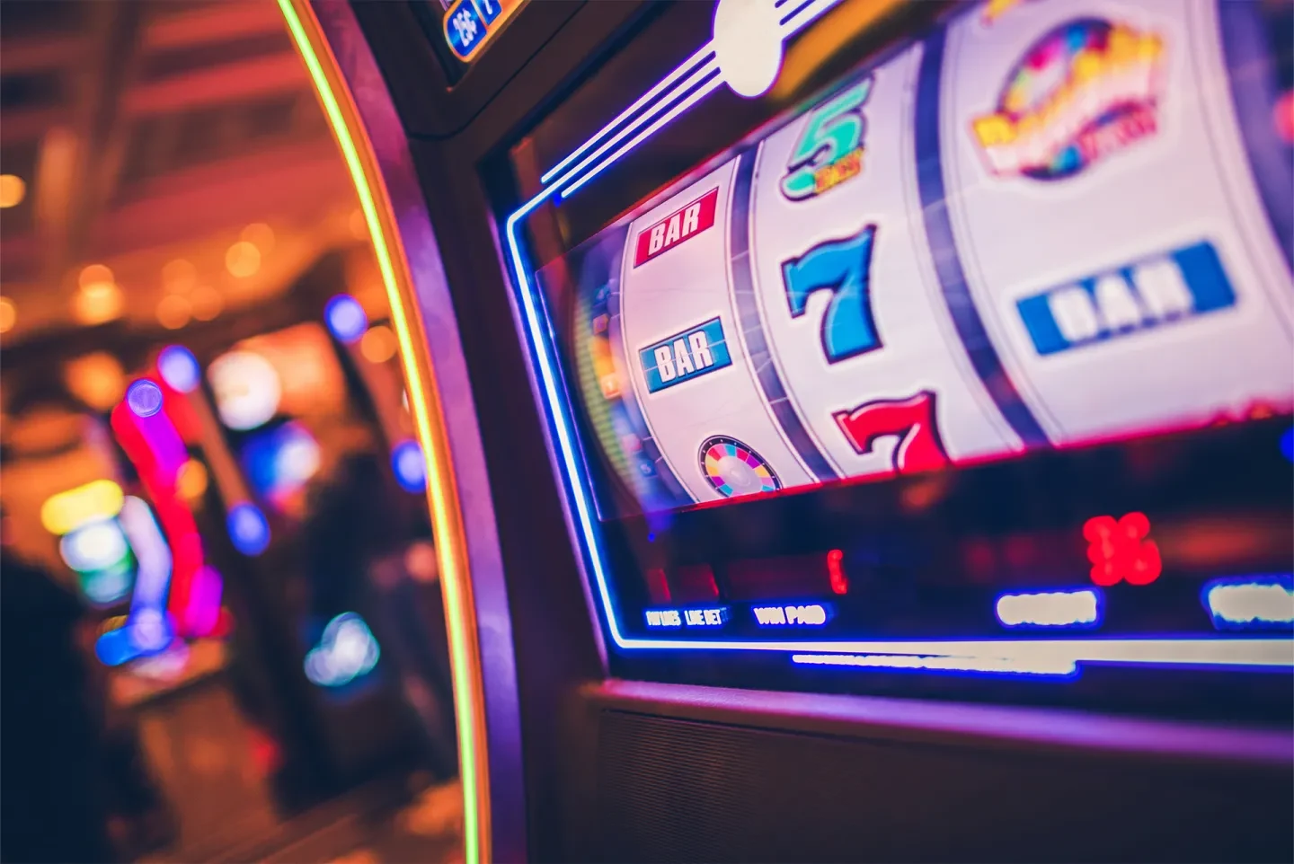 Close-up of a colorful slot machine showcasing spinning reels and buttons.