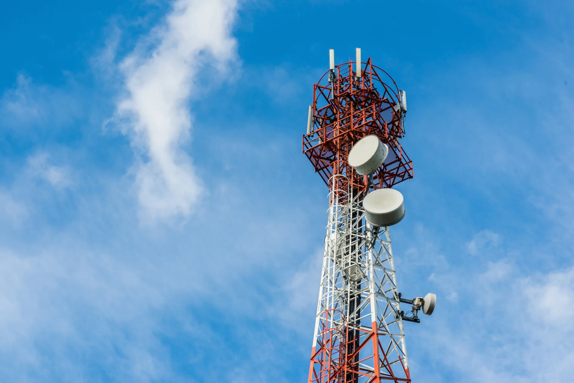 Telecommunications tower against a blue sky for a technology provider's case
