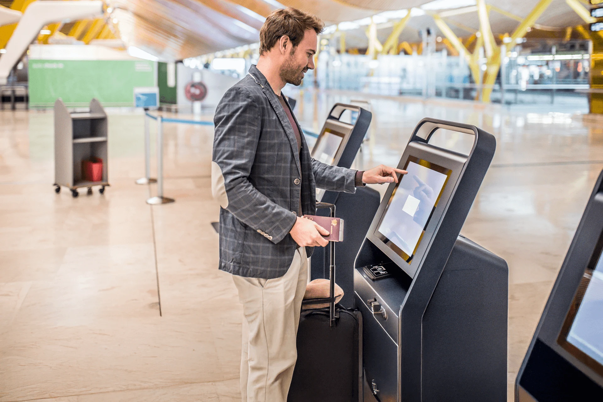 A traveler using a self-service kiosk at an airport.