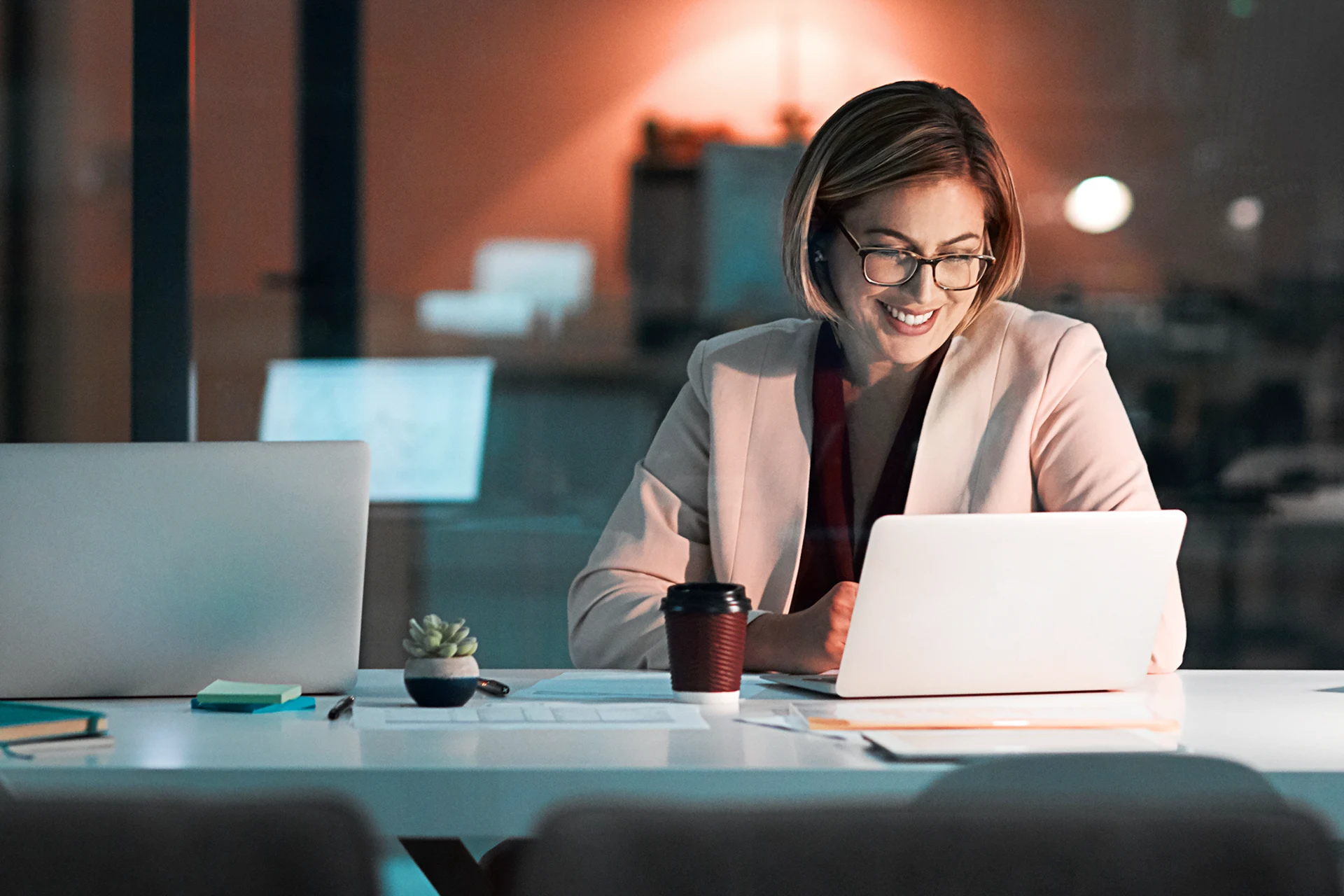 Professional working on a laptop at a desk in an office setting
