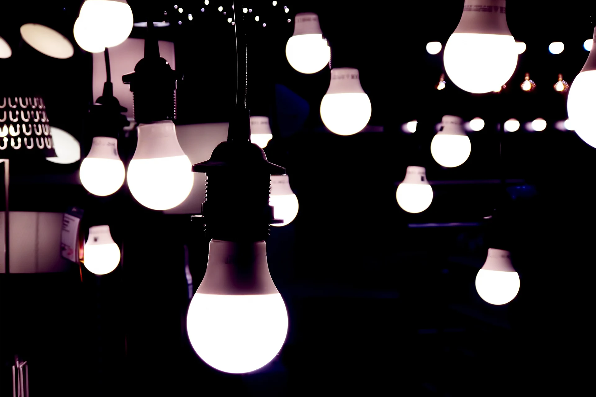 Nine LED light bulbs illuminated in a dark environment