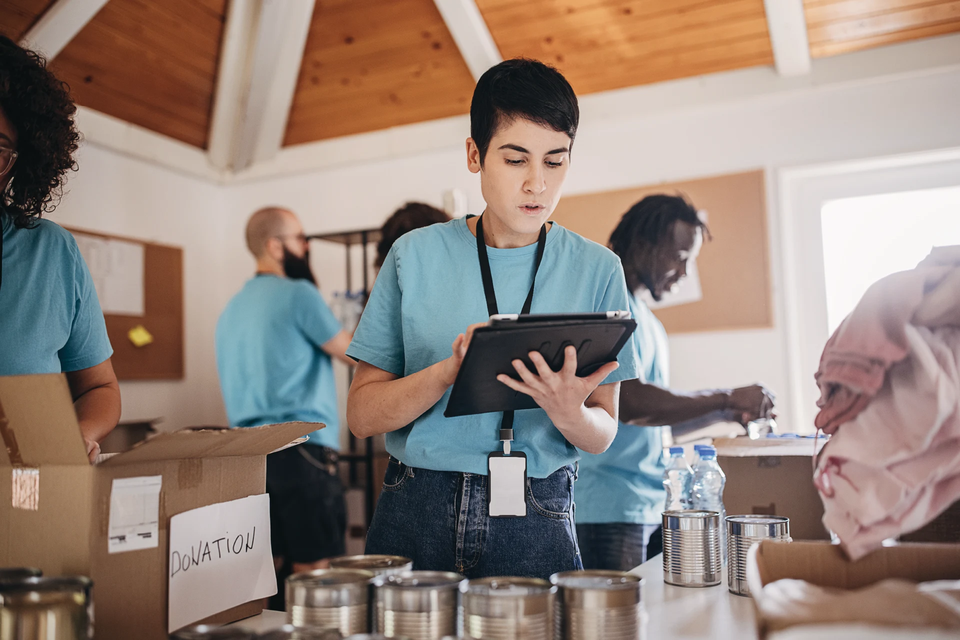 Volunteer using a tablet to manage donations at a non-profit organization