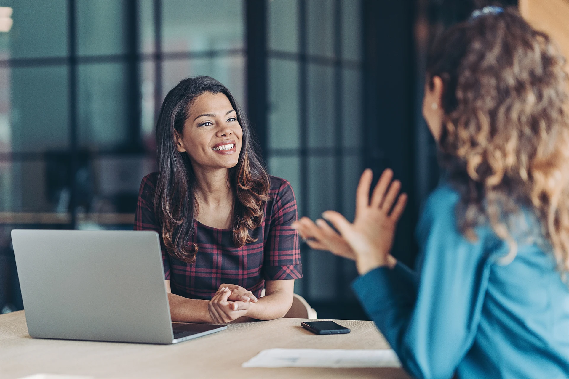 Two professionals discussing strategies in a modern office setting