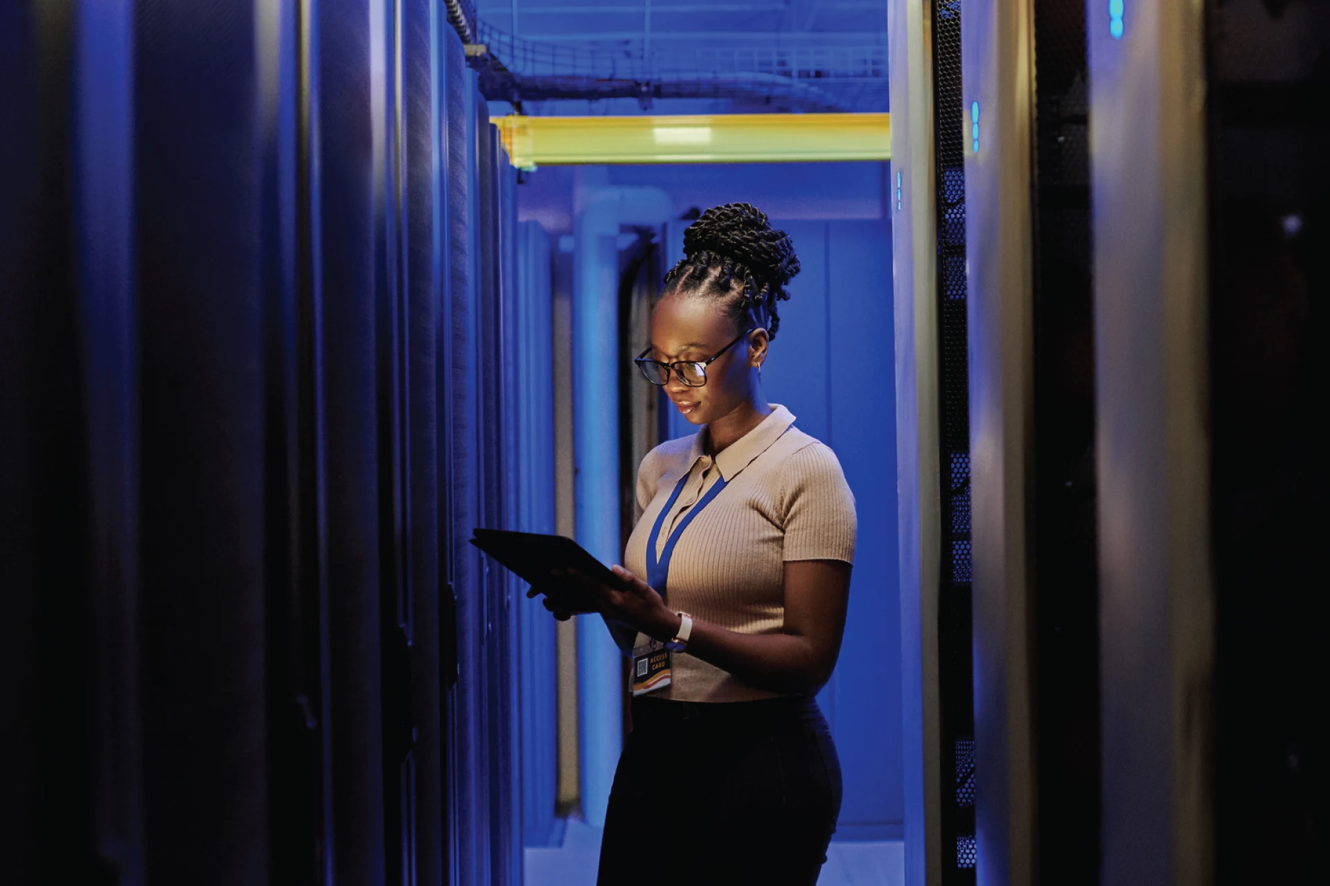 Professional using a tablet in a data center for cloud migration assistance
