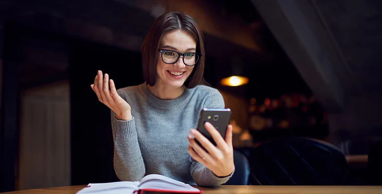 Professional using smartphone and gesturing during conversational ZenVerse tool