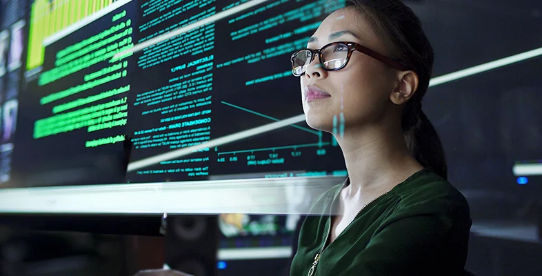 Tech professional analyzing big screen analytics charts for Gartner data center